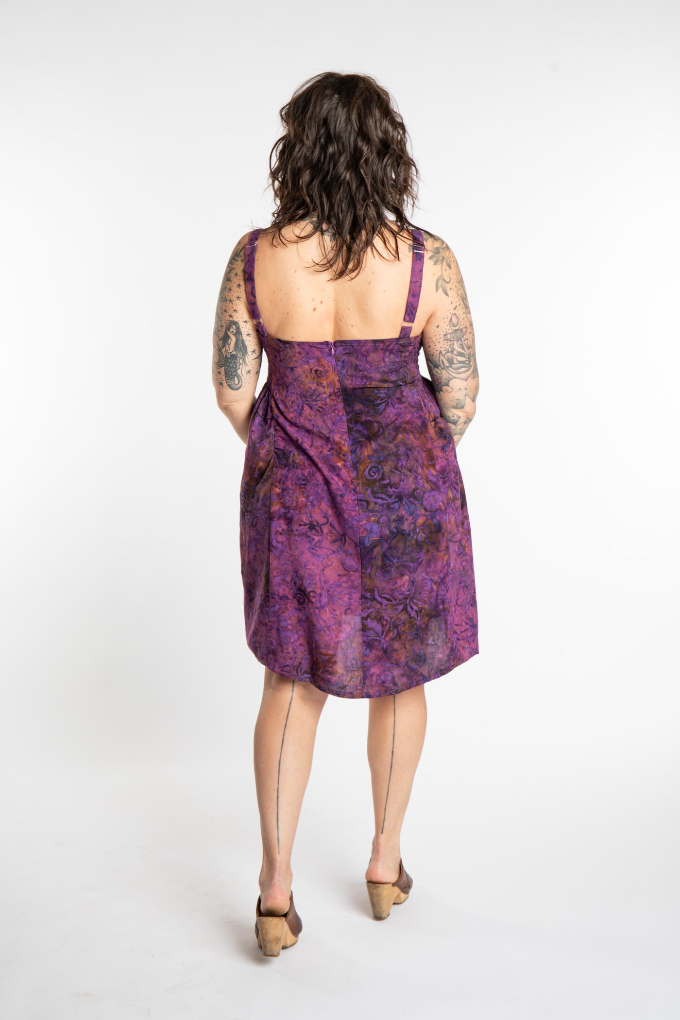 Morgan is wearing the Purple Paradise Surya Batik Sundress in size M 