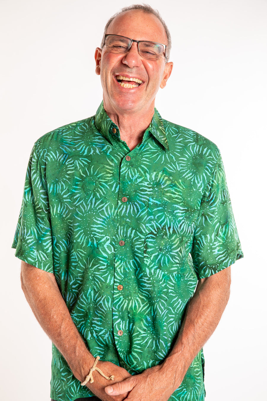 Ross wearing a M green floral batik shirt in Forest Green