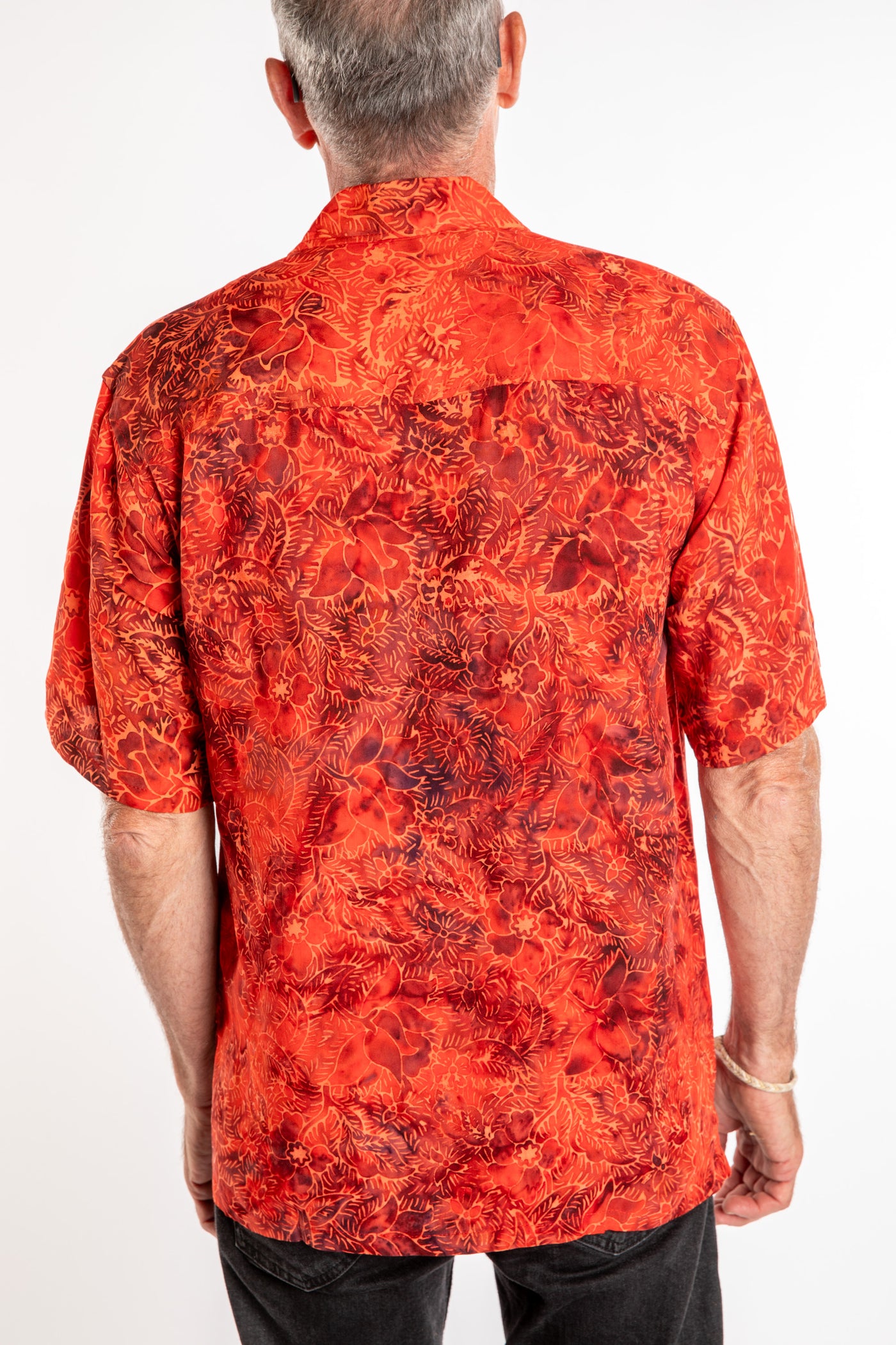 Ross wearing a M red floral batik shirt in Persimmon