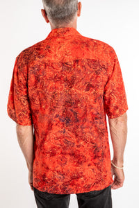 Ross wearing a M red floral batik shirt in Persimmon