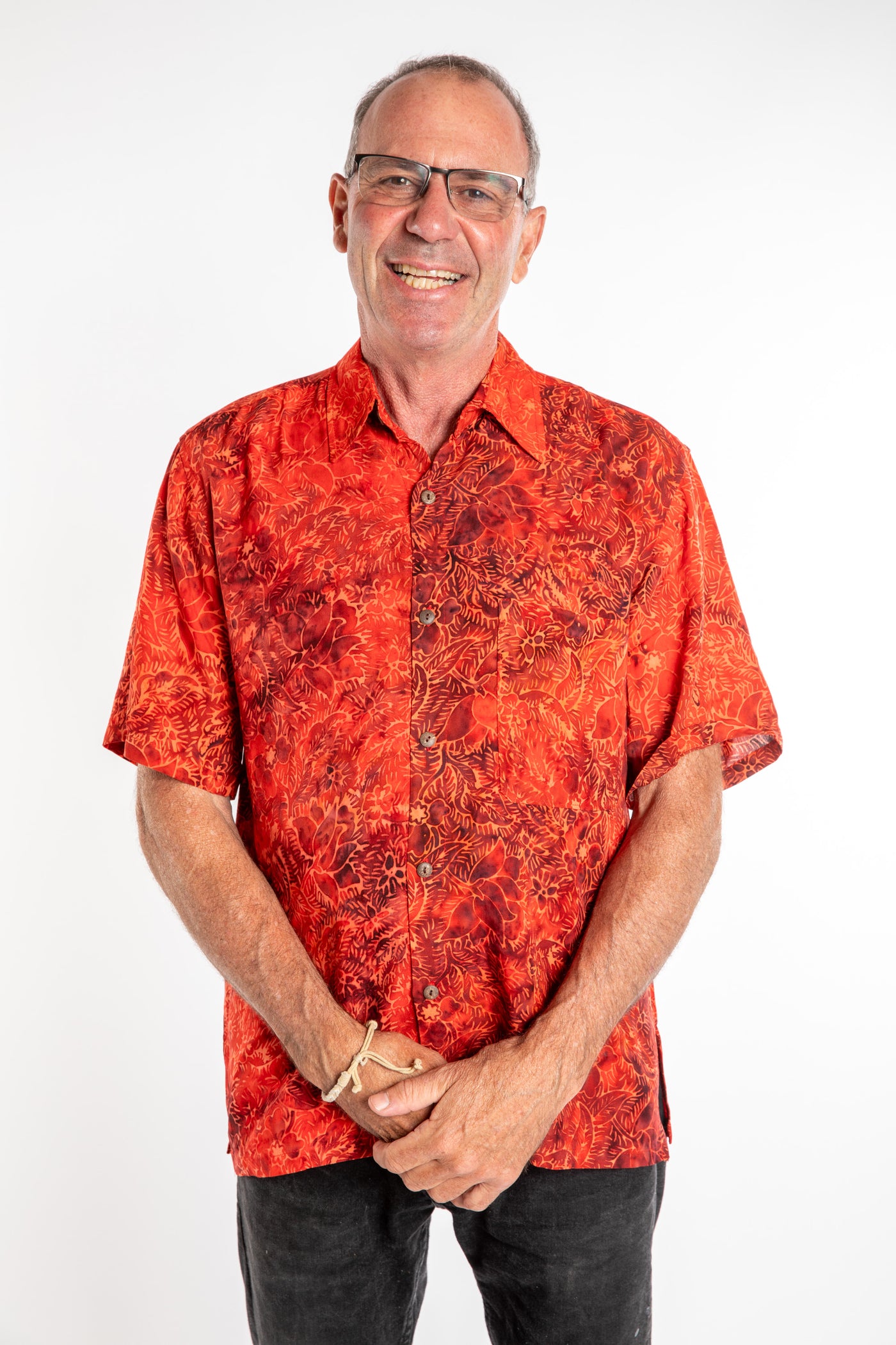 Ross wearing a M red floral batik shirt in Persimmon