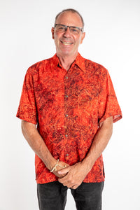Ross wearing a M red floral batik shirt in Persimmon