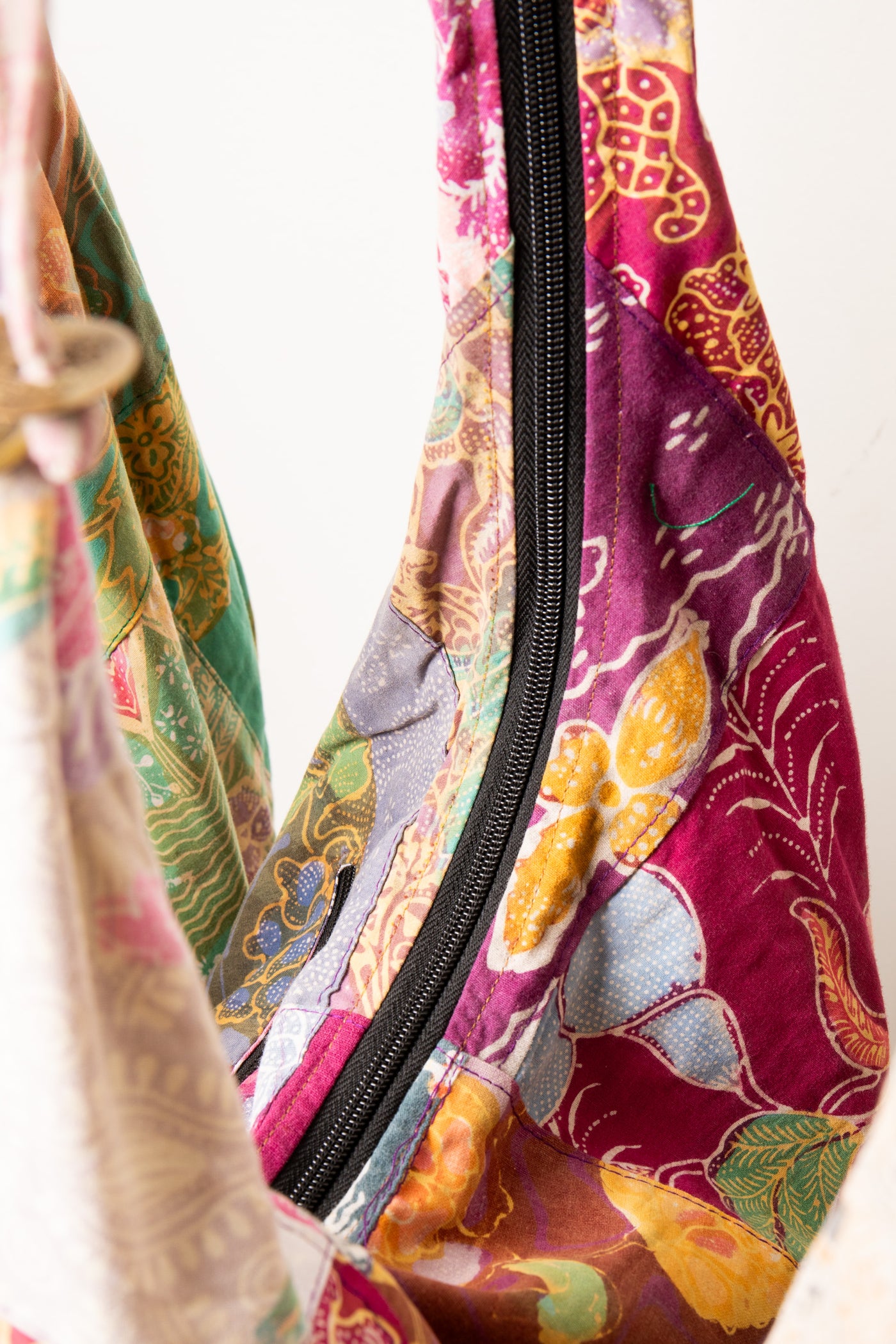 Assorted colorful patterned java patch moon bag detail of zipper