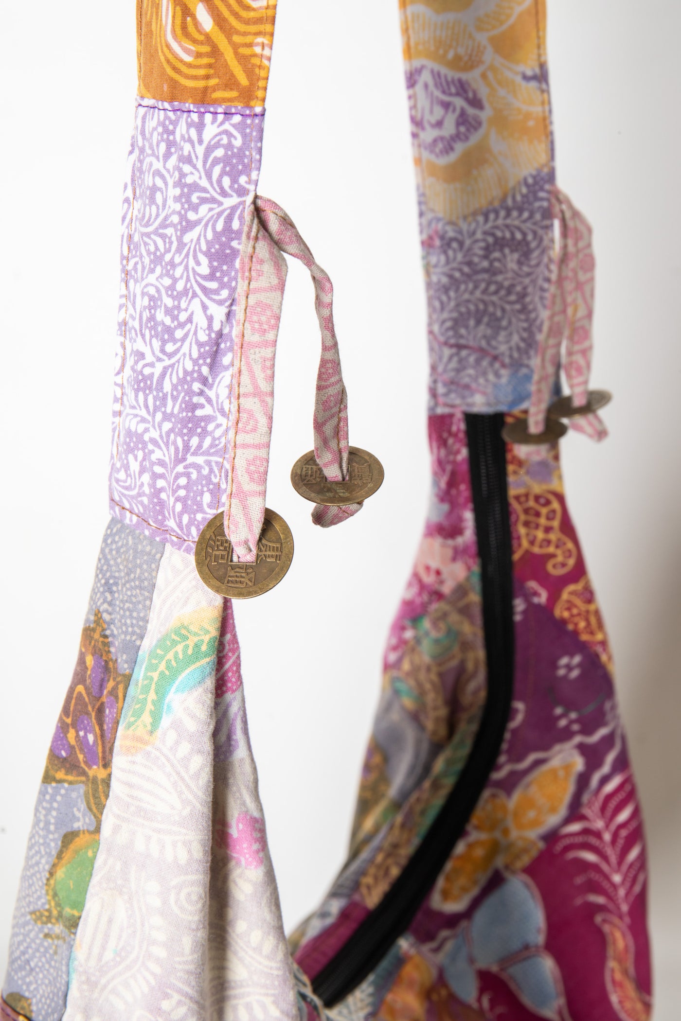 Assorted colorful patterned java patch moon bag detail of coin tassels