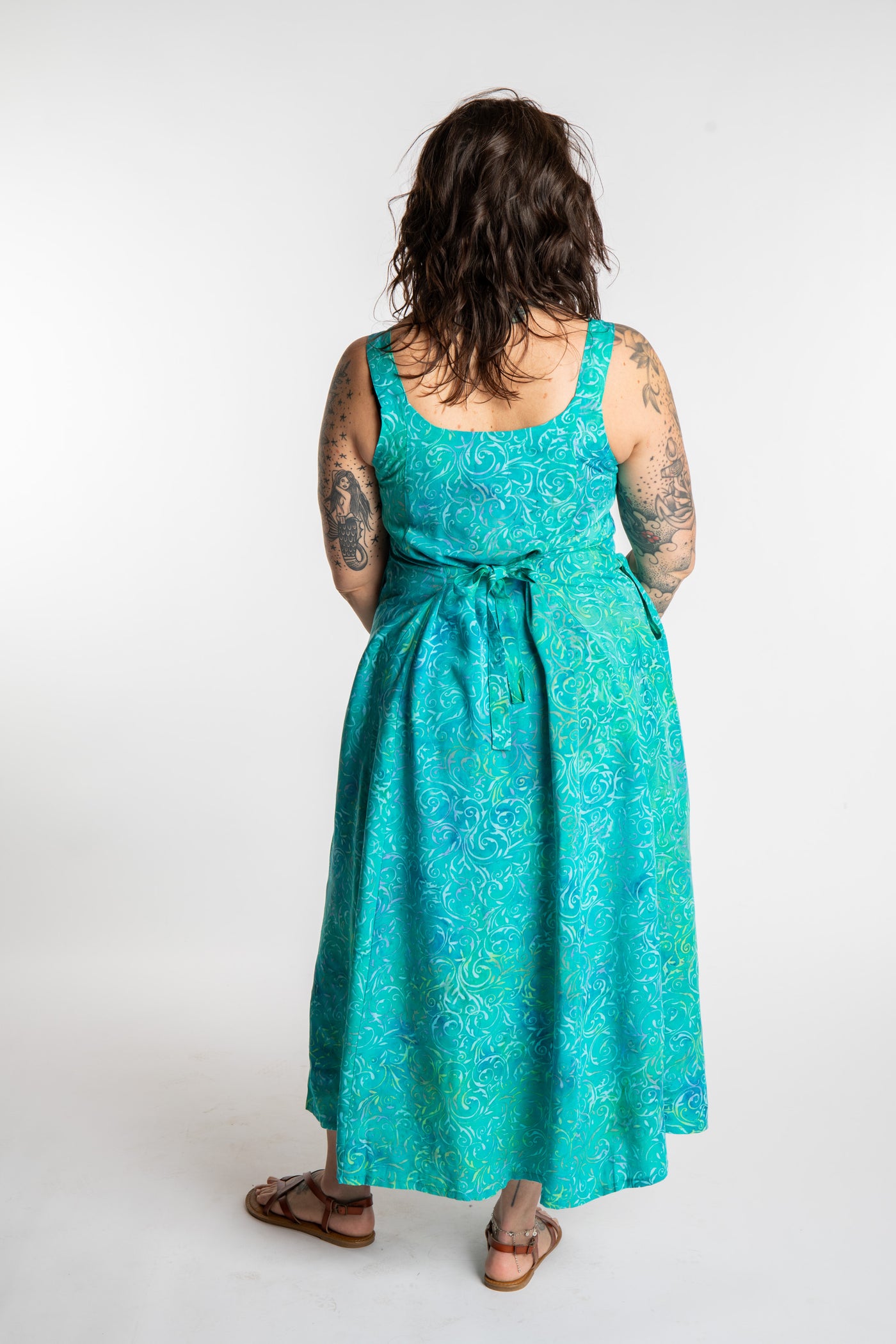 Morgan is wearing the Bright Teal Ani Button Batik Maxi Dress in size M