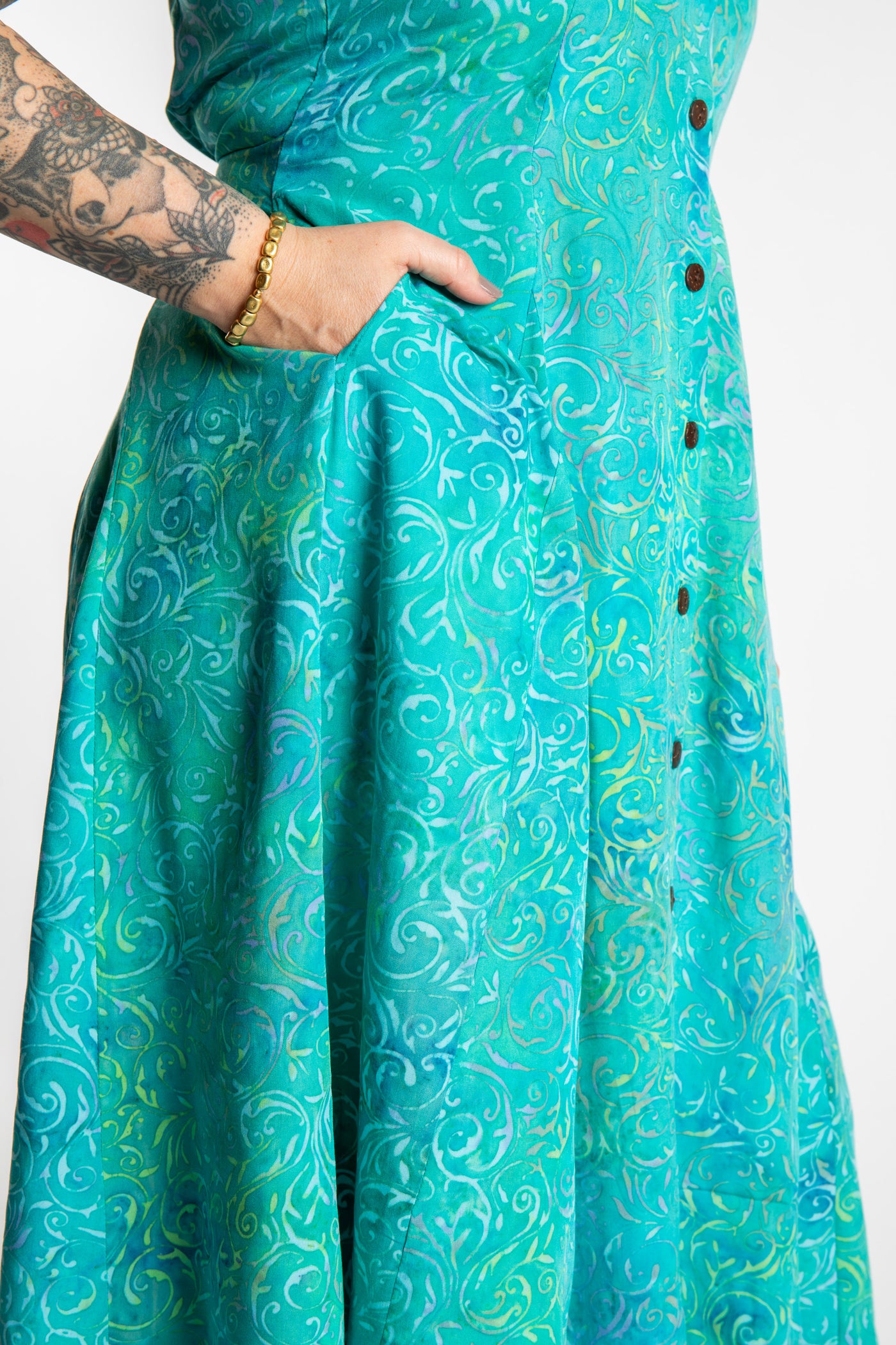 Morgan is wearing the Bright Teal Ani Button Batik Maxi Dress in size M
