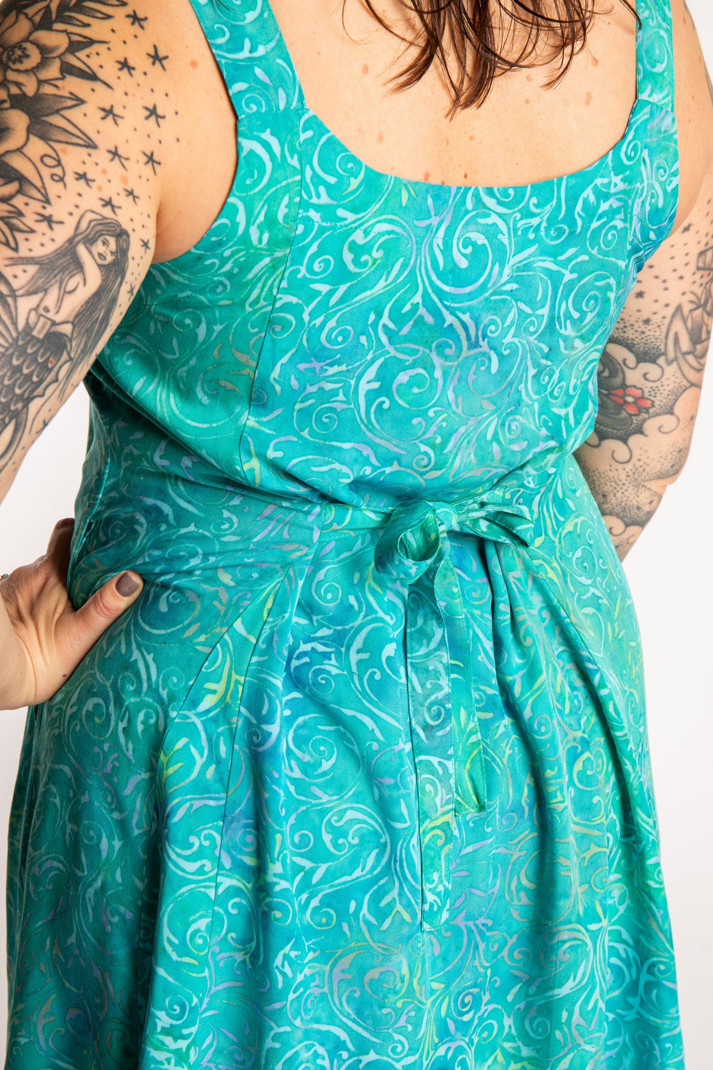 Morgan is wearing the Bright Teal Ani Button Batik Maxi Dress in size M