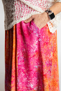 Morgan is wearing the Sunkissed Coral Pink Ani Button Batik Maxi Dress in size M
