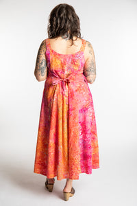 Morgan is wearing the Sunkissed Coral Pink Ani Button Batik Maxi Dress in size M