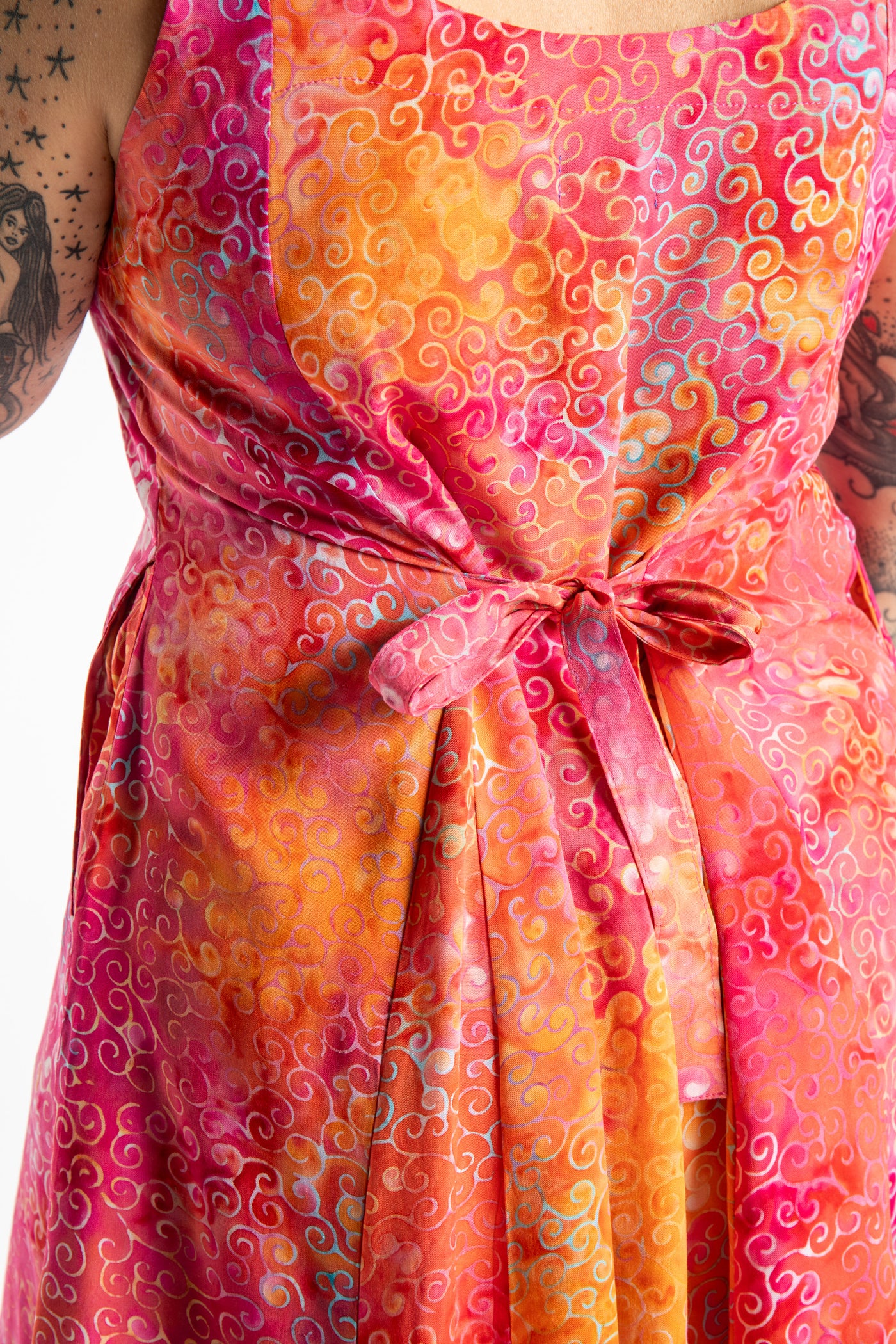 Morgan is wearing the Sunkissed Coral Pink Ani Button Batik Maxi Dress in size M