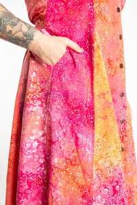 Morgan is wearing the Sunkissed Coral Pink Ani Button Batik Maxi Dress in size M