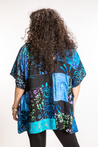 Susan is wearing the S/M Blue patchwork batik top