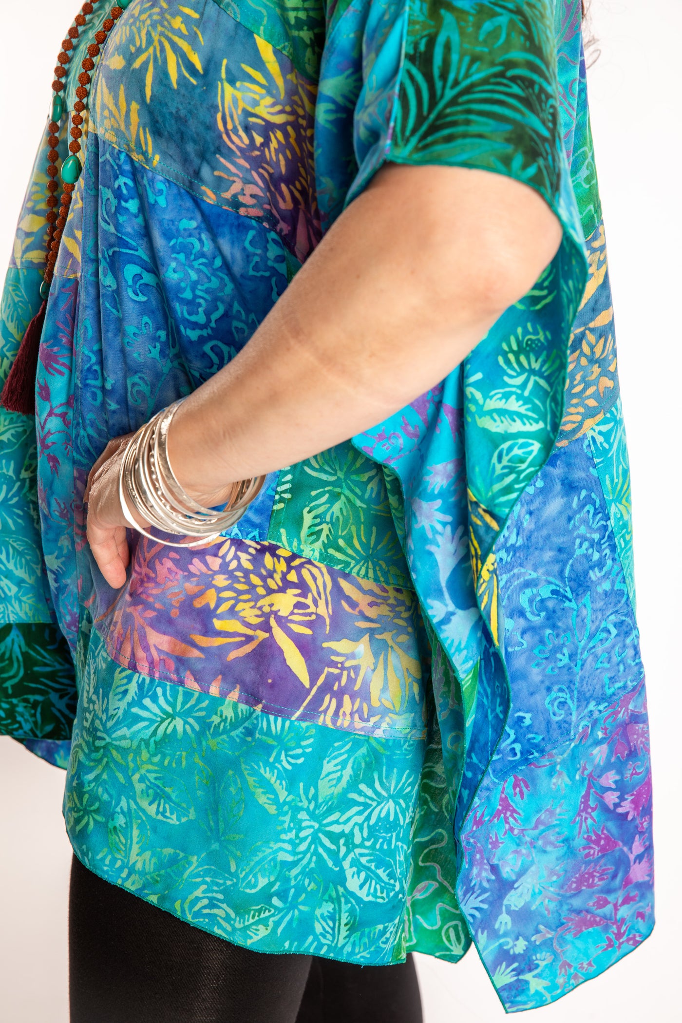 Susan is wearing the S/M Blue patchwork batik top in Turquoise