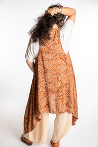 Susan wearing a long batik patterned vest in Brown