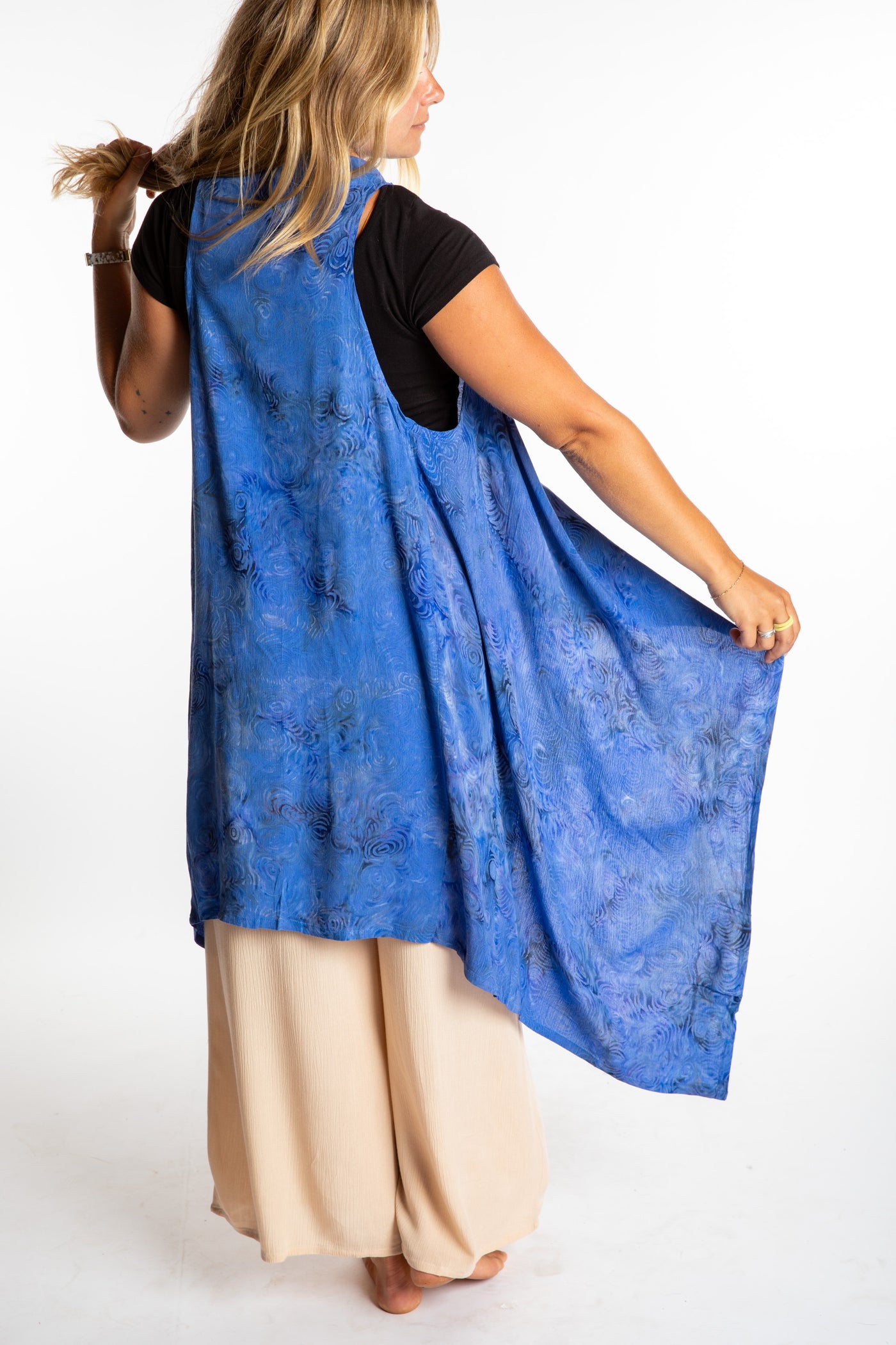Sophie wearing a long batik patterned vest in Deep Blue
