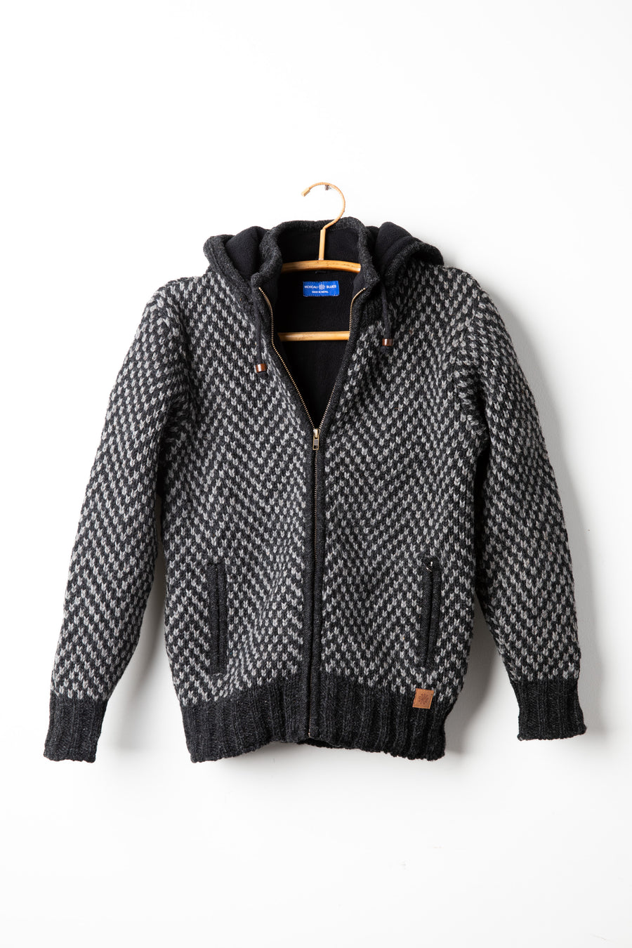 Charcoal checkered wool hooded jacket hanging on hanger