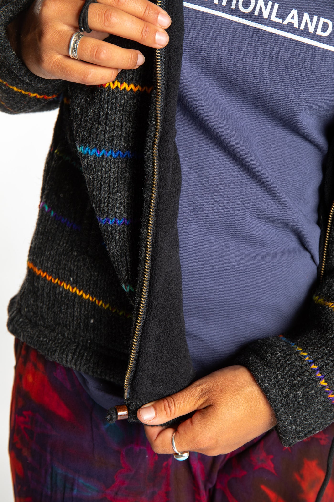 detail of the zipper on the rainbow striped wool hoodie jacket