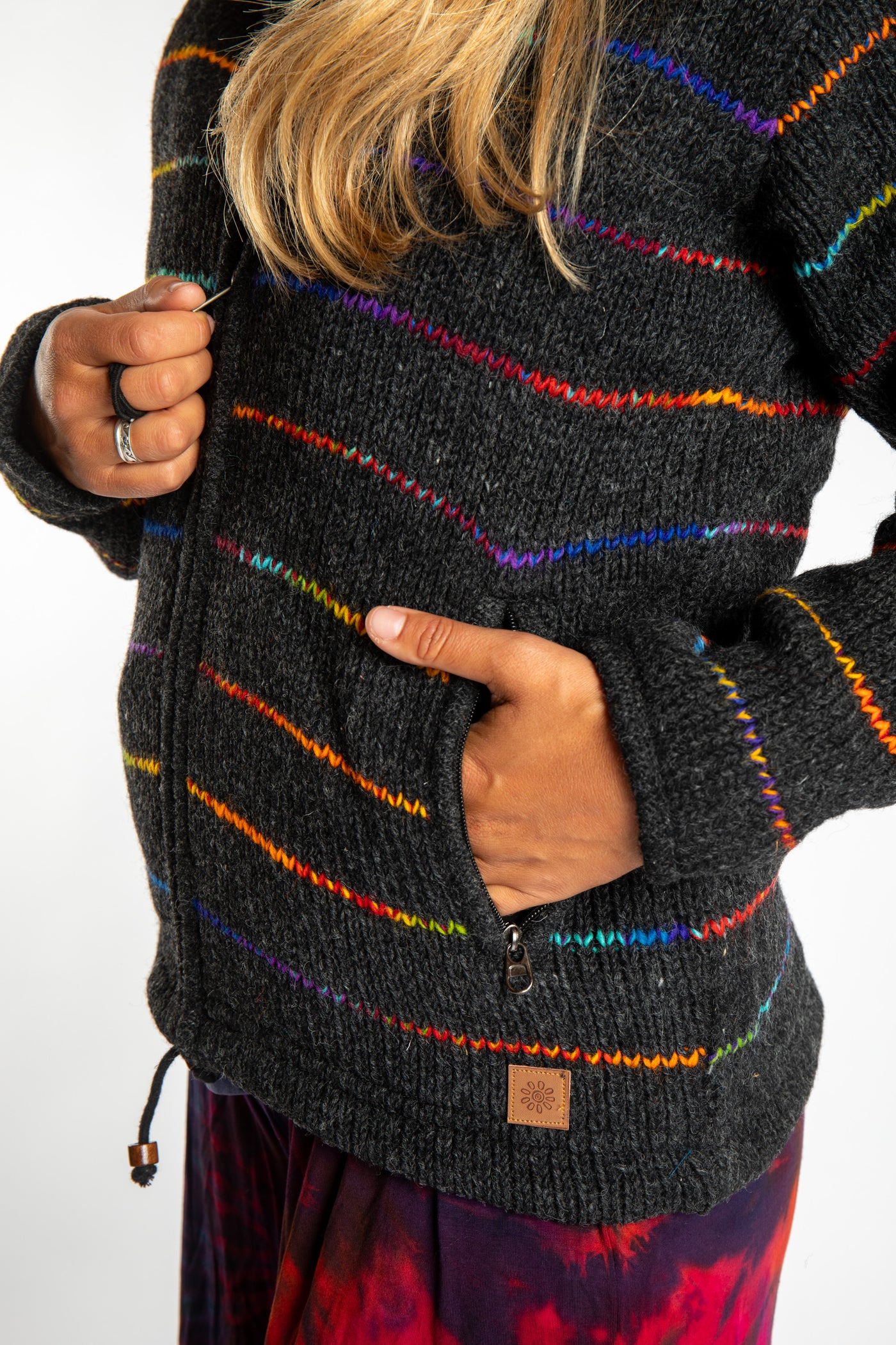 detail of the pocket on the rainbow striped wool hoodie jacket