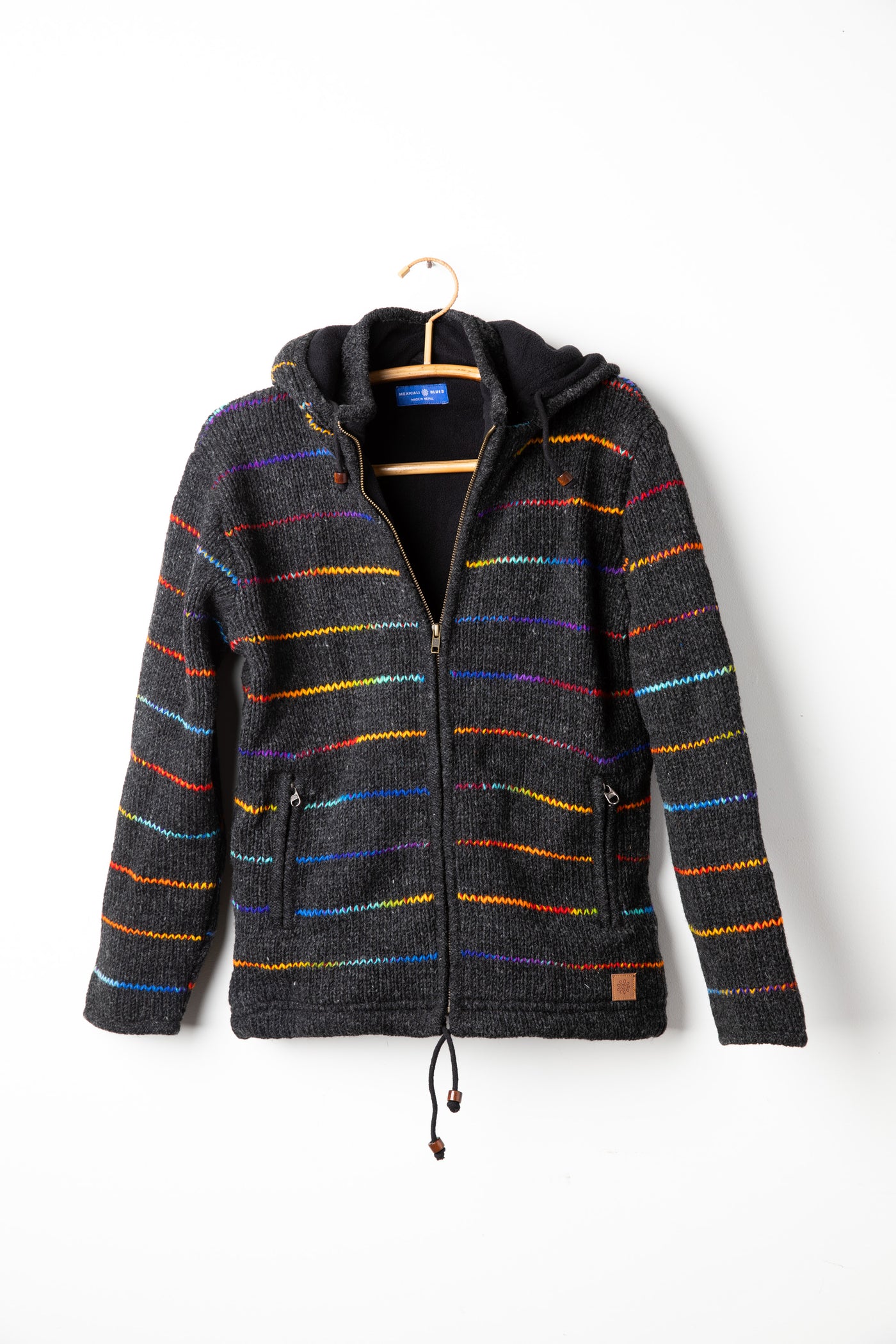 Rainbow striped wool hooded jacket hanging on hanger