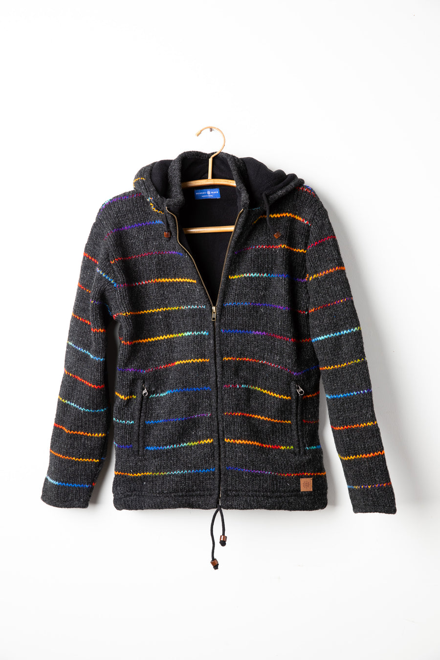 Rainbow striped wool hooded jacket hanging on hanger