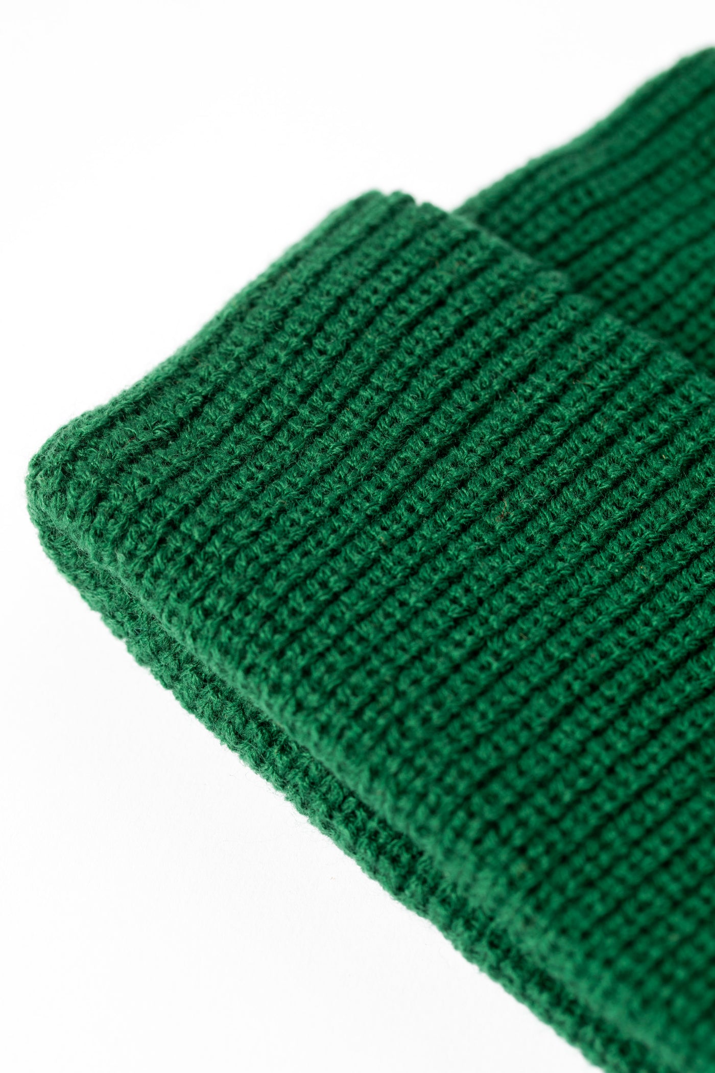 Detail of Forest Green knit acrylic beanie with a floral patch