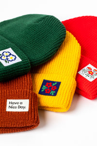 Collection of the four acrylic beanies with patches