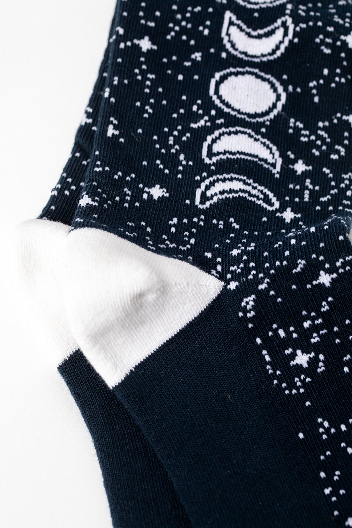 Pair of Black socks with a moon phase and night sky pattern 