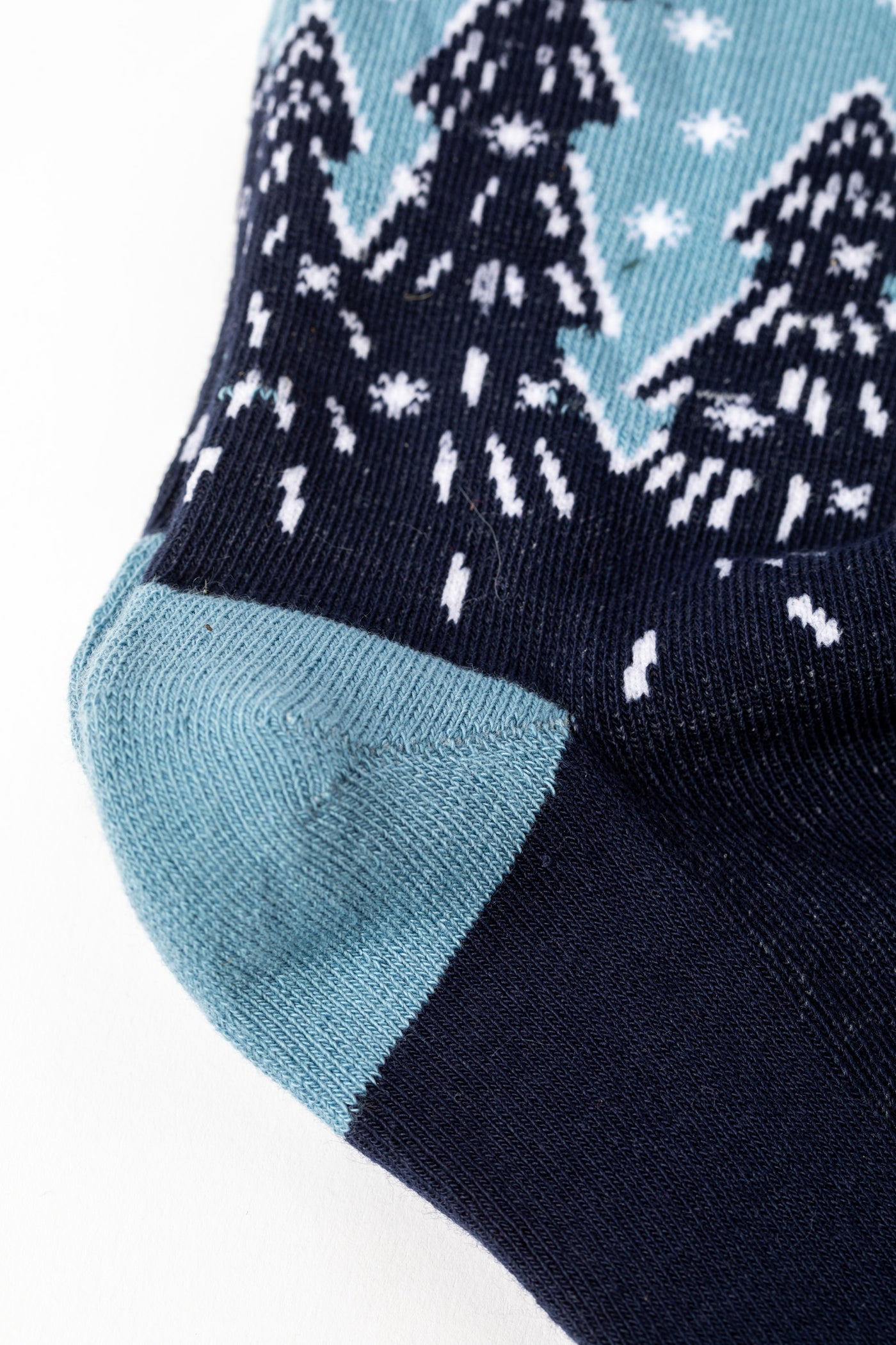 Blue pair of socks with winter wonderland design