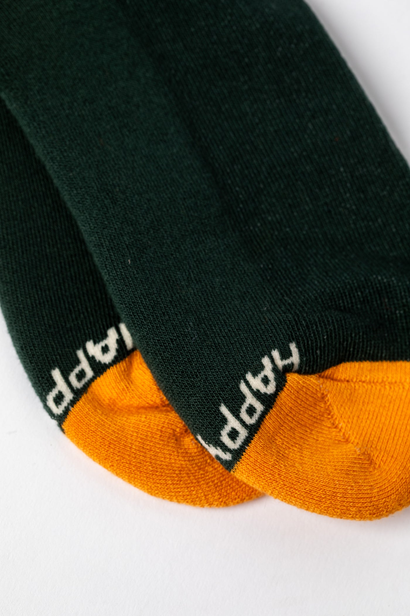Multicolor green socks with orange accents and a nature-themed design.
