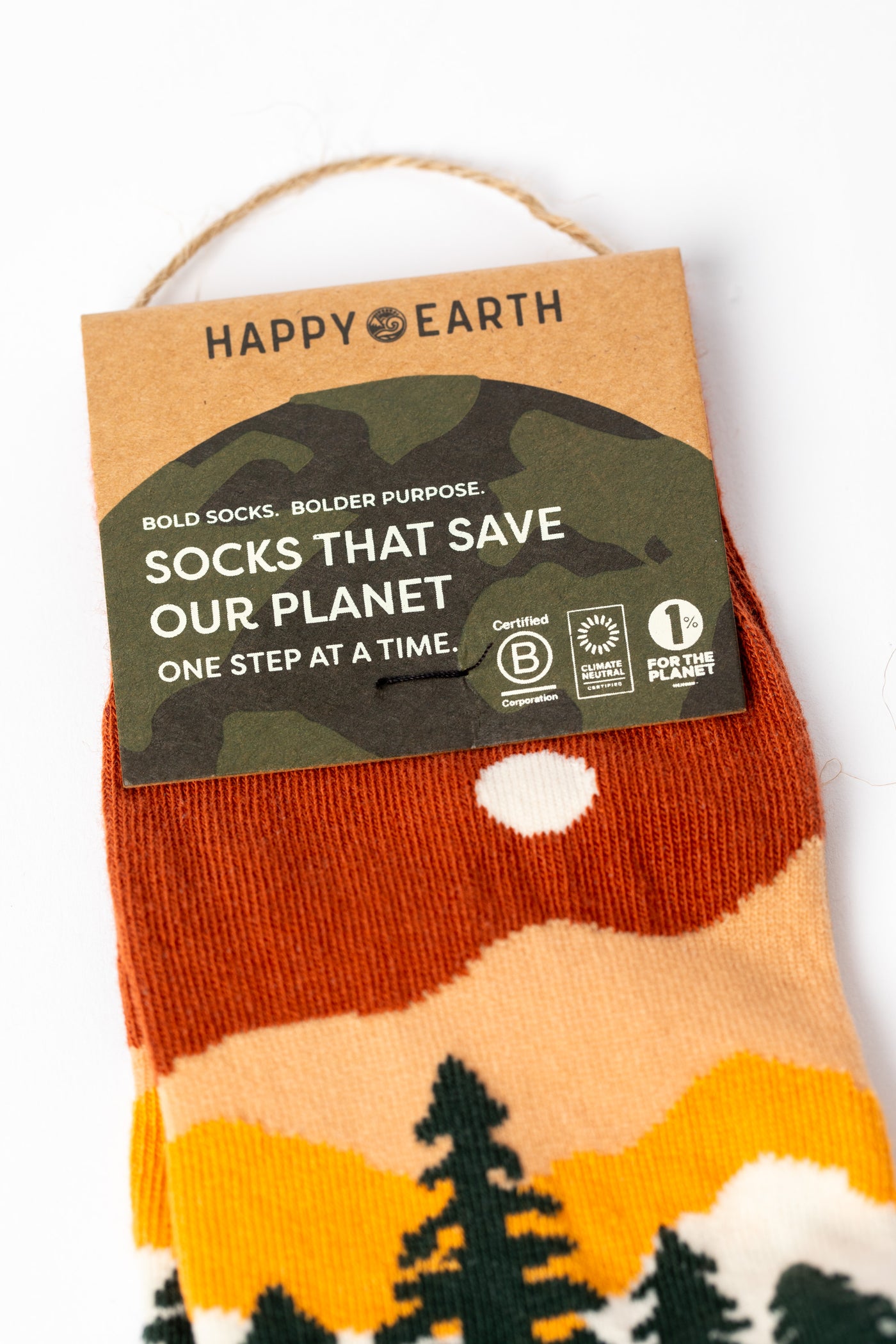 Multicolor green socks with orange accents and a nature-themed design.