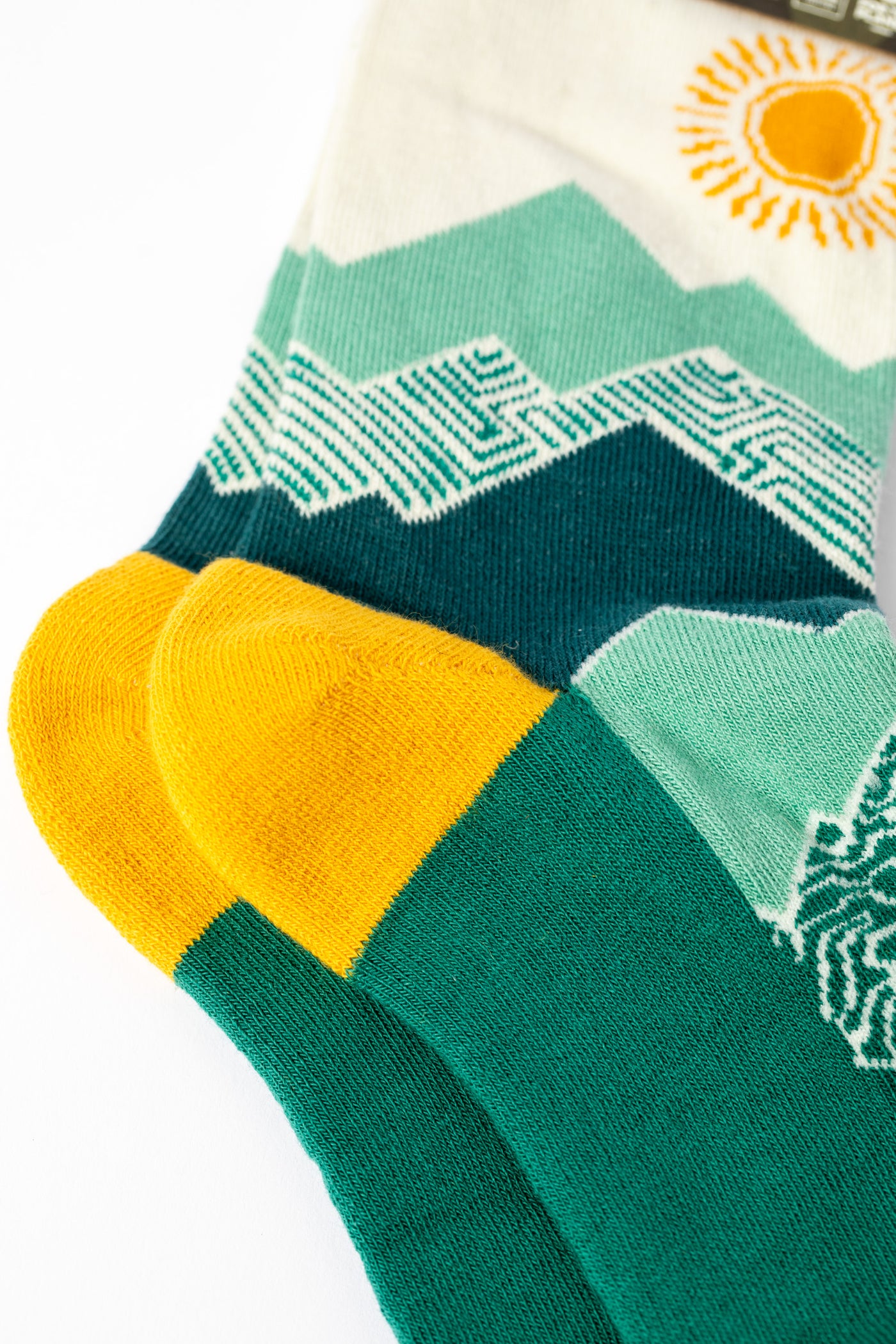 Green and yellow multicolor socks with mountain and sun design