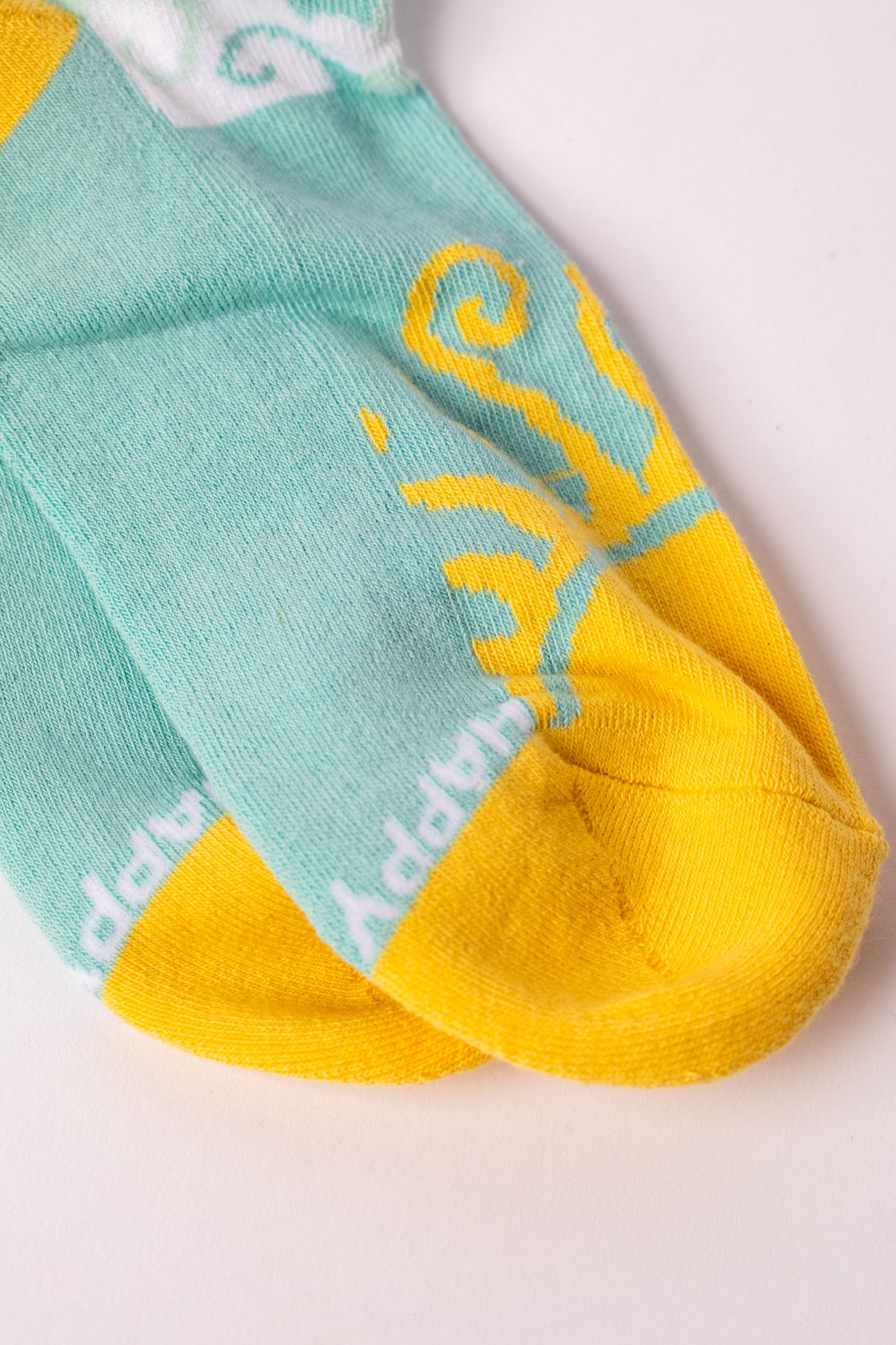 Turquoise and yellow Sky Blue socks with a cloud pattern.