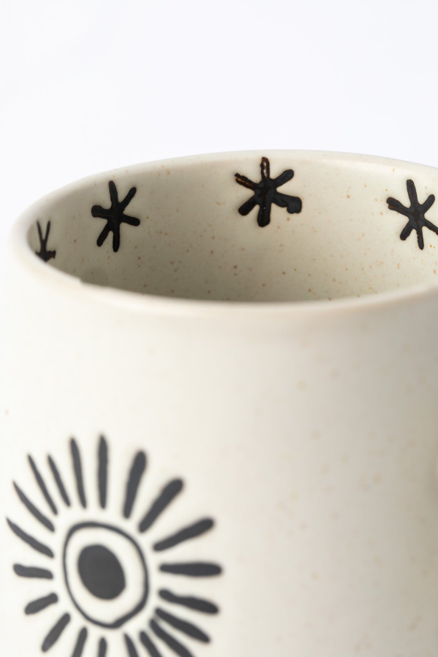 Interior of Crescent Moon and Sun Mug showing star etchings. 