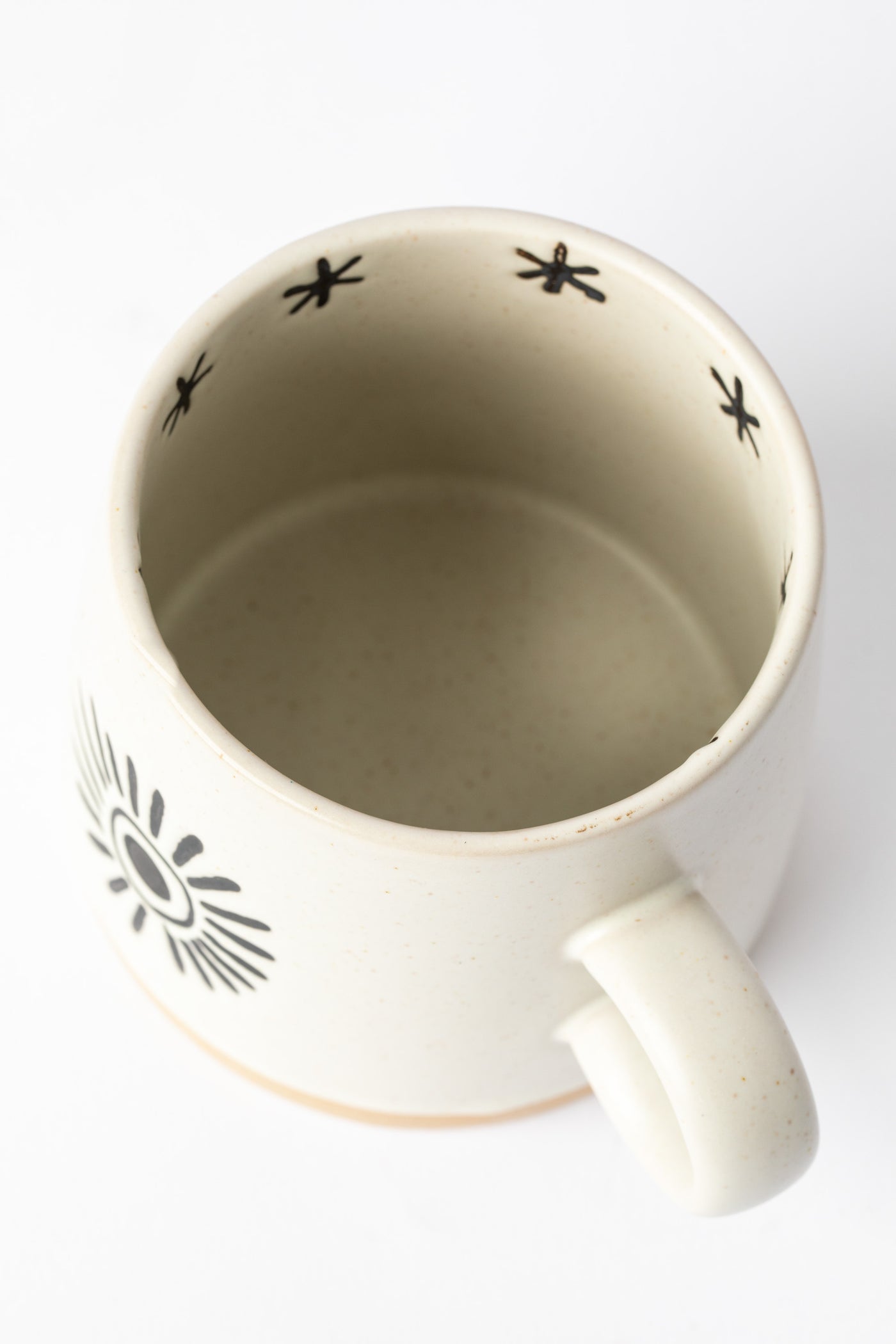 Interior of Crescent Moon and Sun Mug showing star etchings.