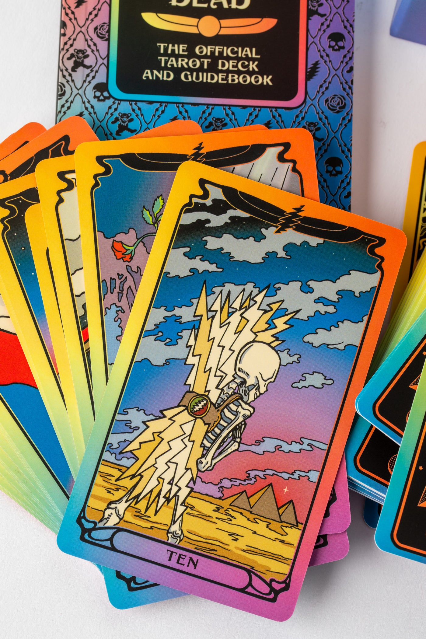 Tarot card featuring skeleton and lightning bolts with desert and pyramid background.