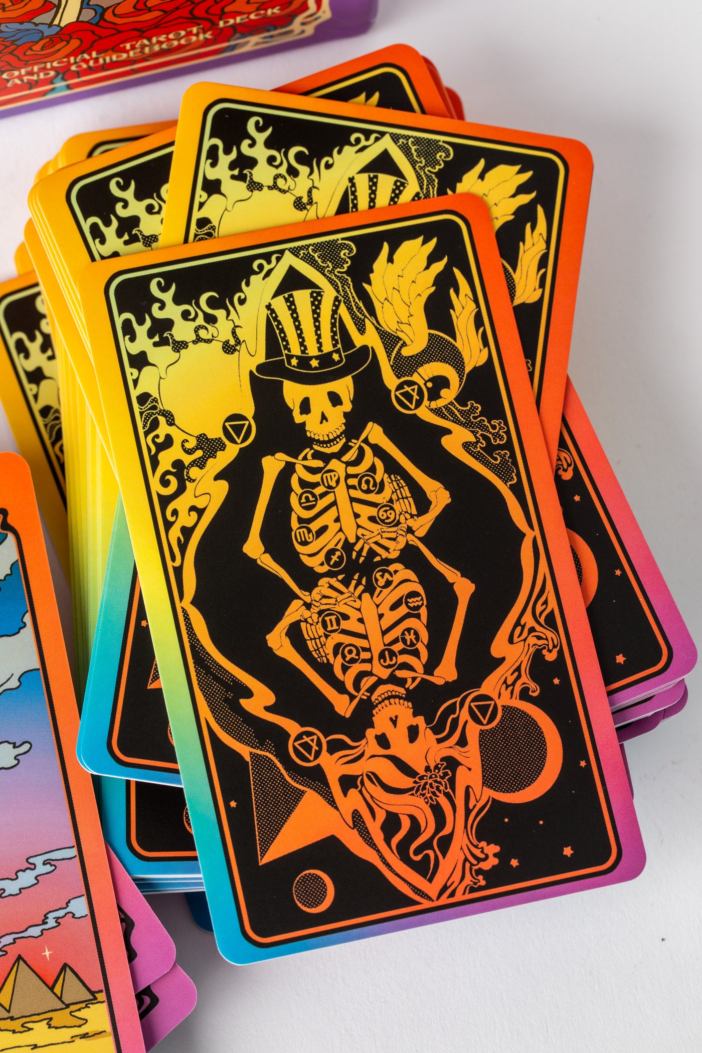 Black and orange tarot card backs with Grateful Dead skeleton art and zodiac symbols.