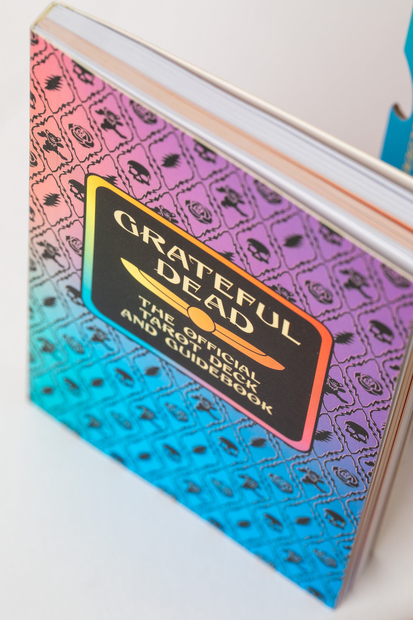 Grateful Dead Tarot guidebook with rainbow skull-and-rose pattern on cover.