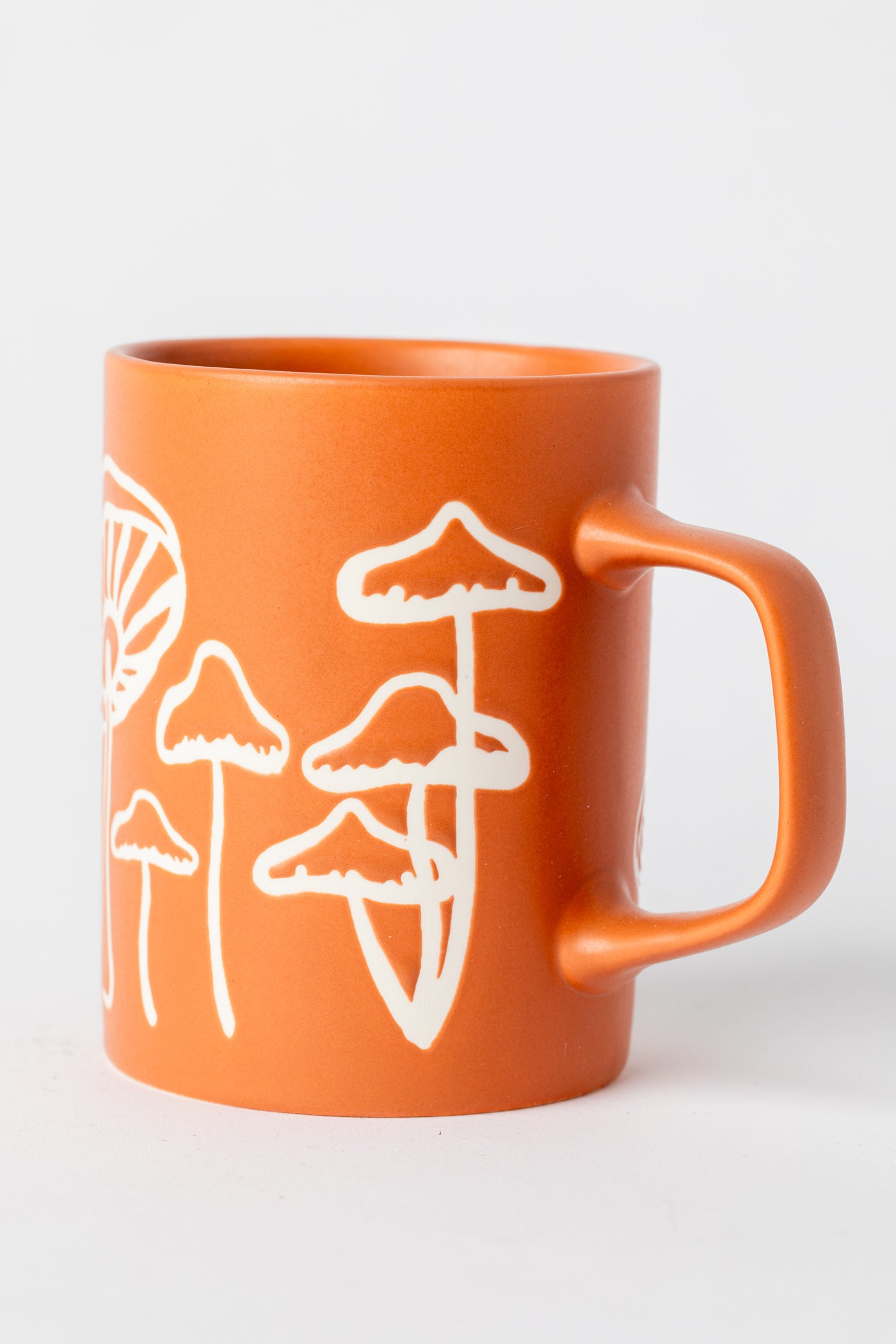 Orange Mushroom Mug with matte finish and hand-drawn mushrooms.