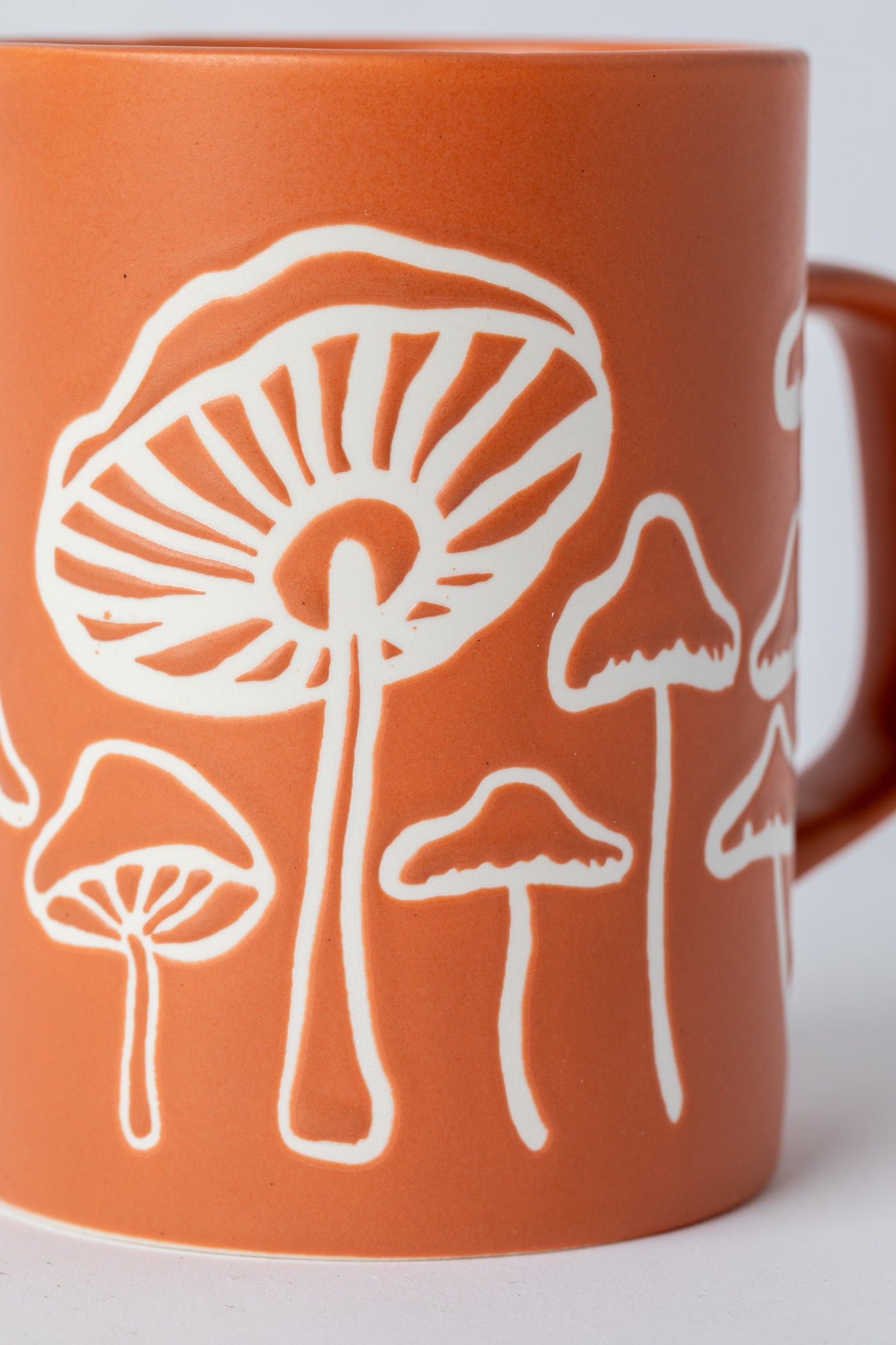 Orange Mushroom Mug with matte finish and hand-drawn mushrooms.