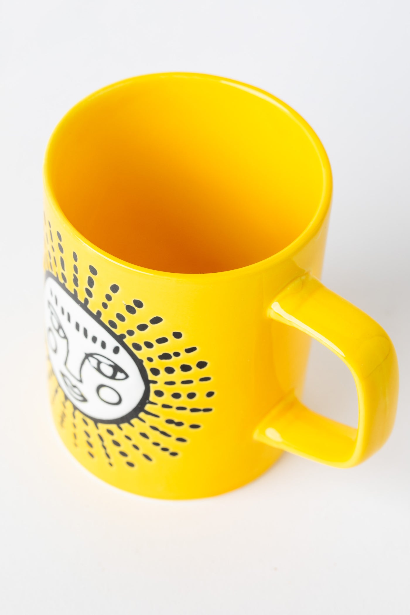Yellow Sun Cuppa Color Mug with embossed face design.