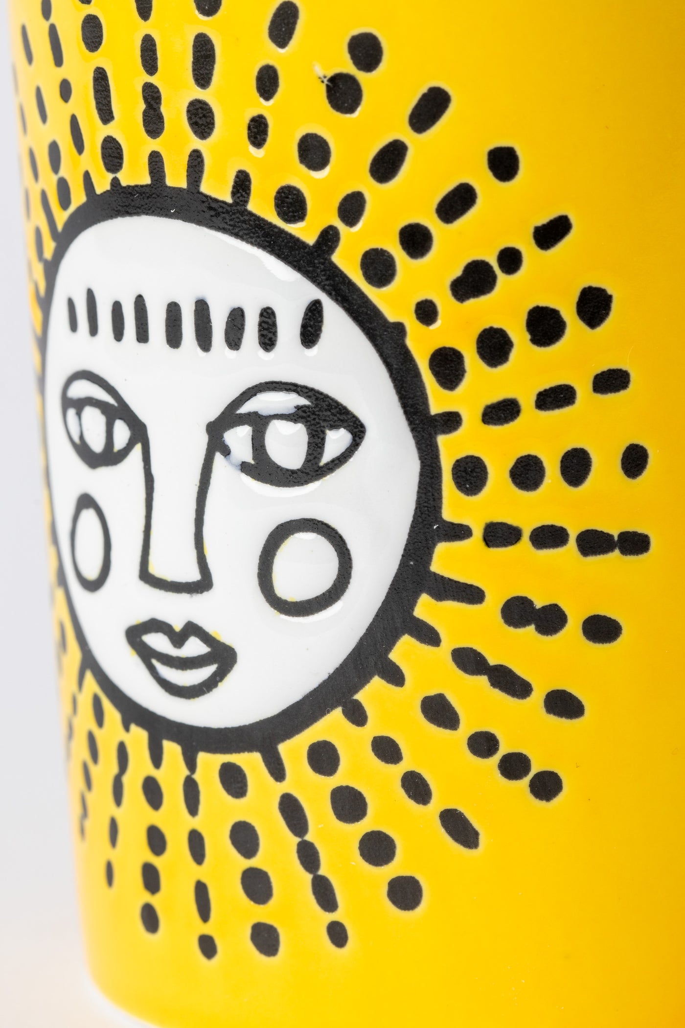 Yellow Sun Cuppa Color Mug with embossed face design.