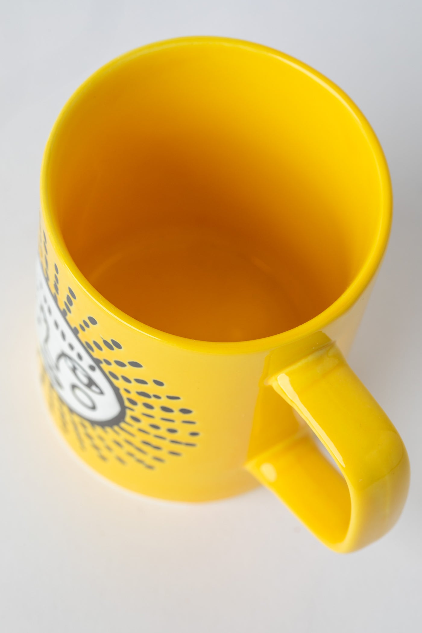 Yellow Sun Cuppa Color Mug with embossed face design.