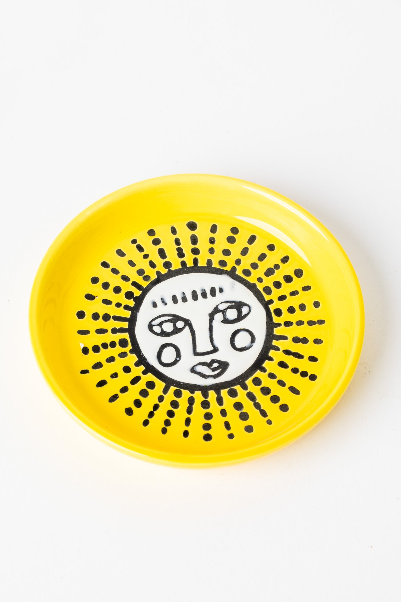 Yellow ceramic coaster with hand-painted sun design