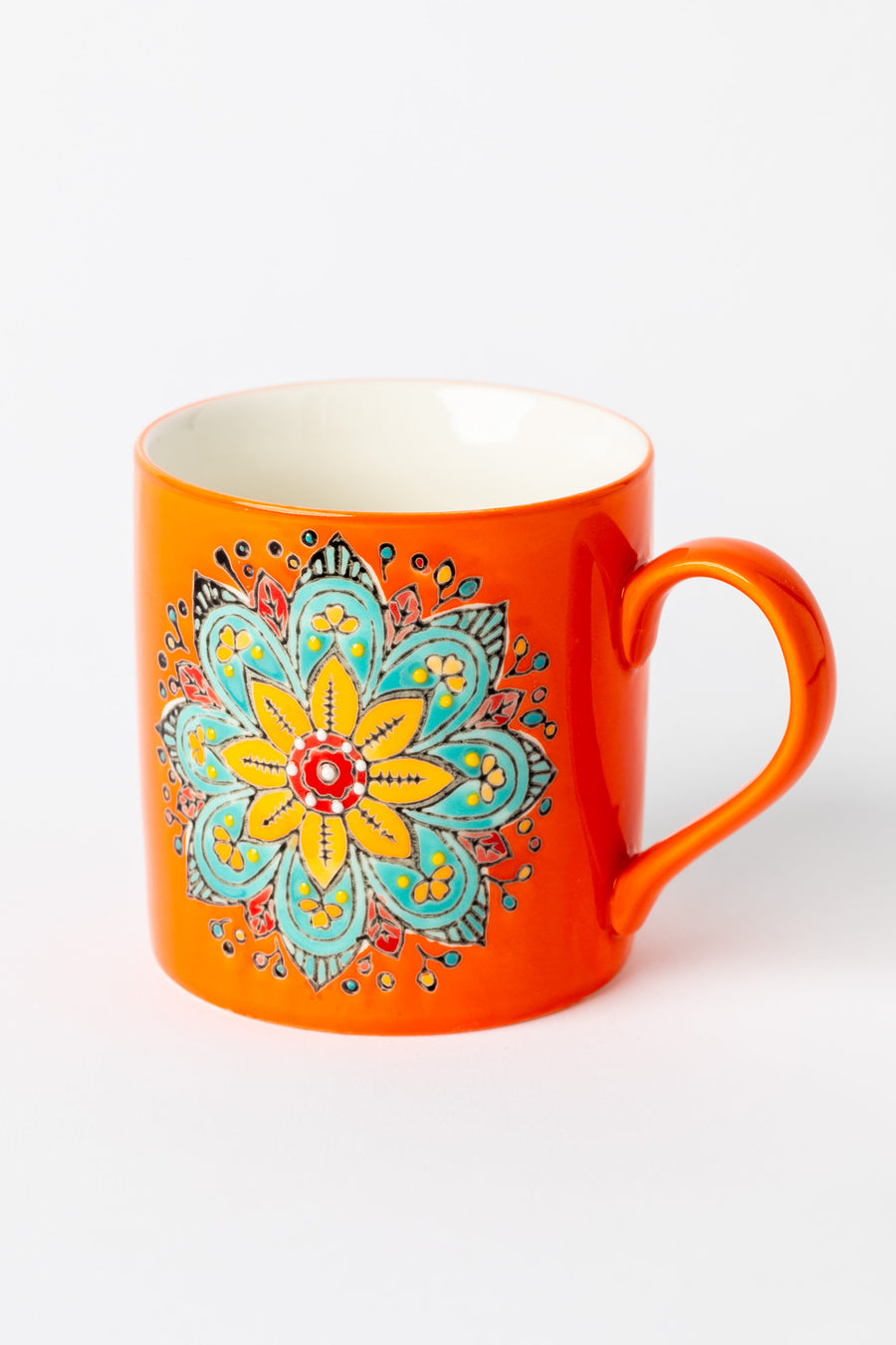Mandala Mug in orange with embossed floral mandala design.