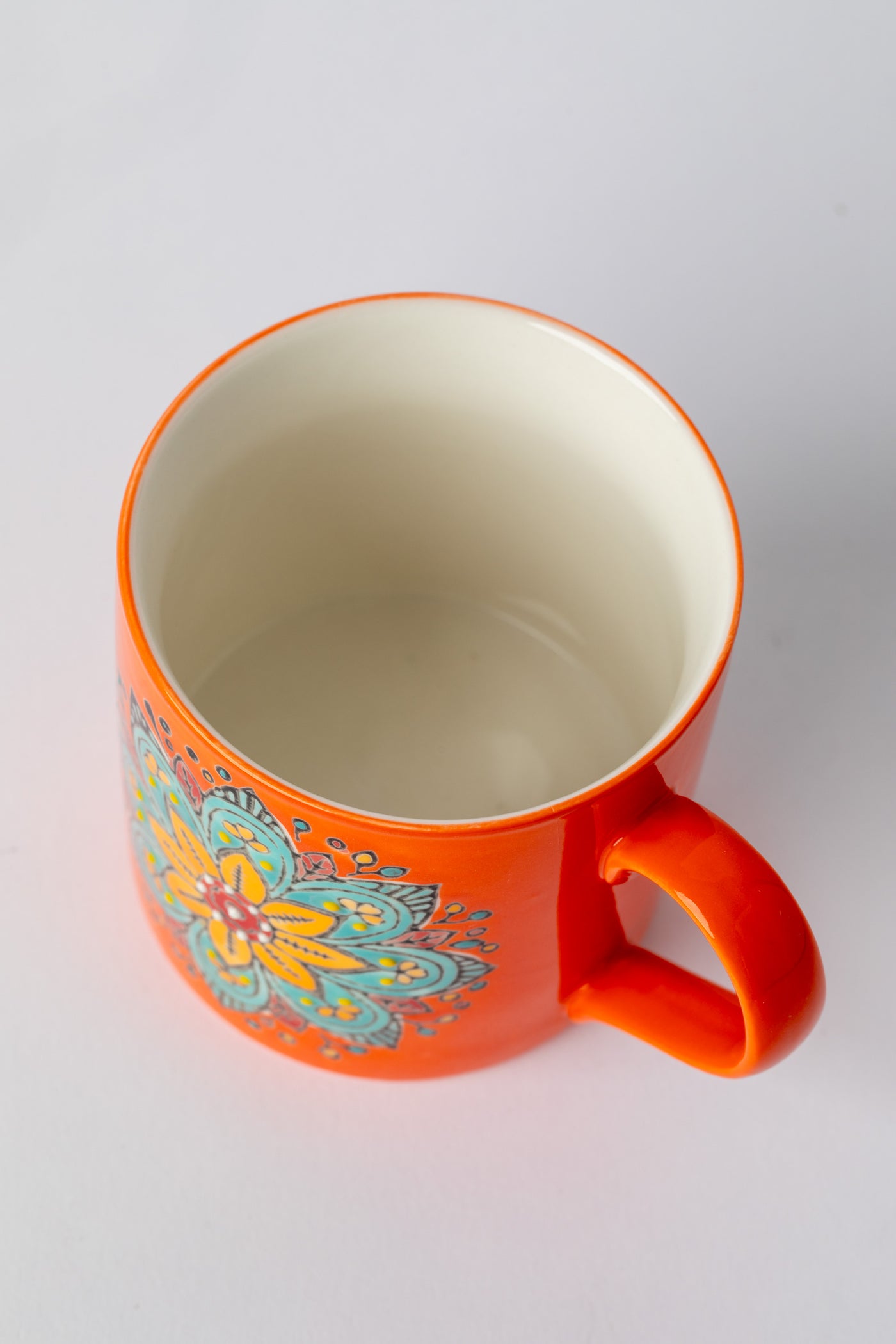 Orange Mandala Mug showing interior cream glaze.