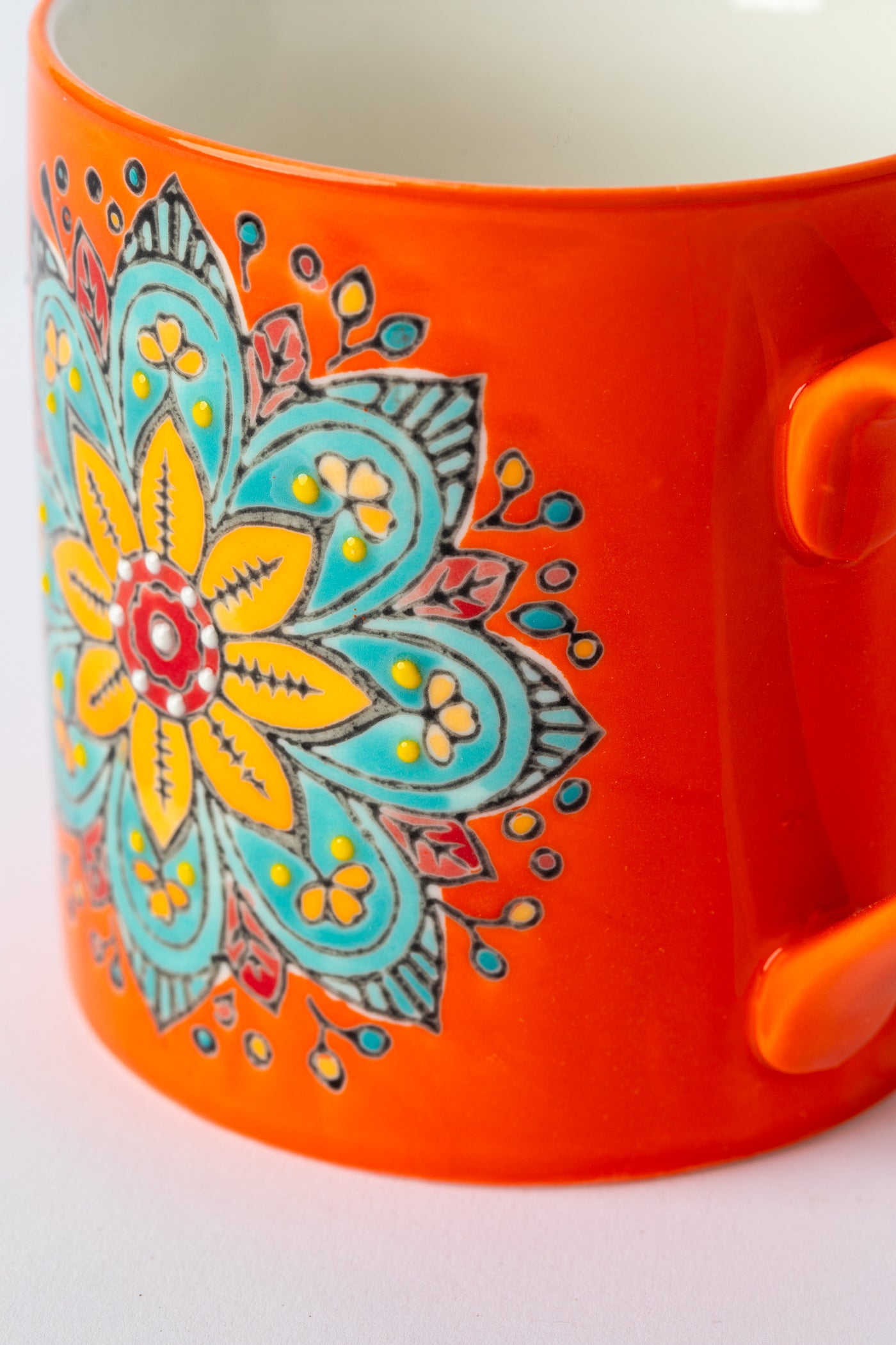 Mandala Mug in orange with embossed floral mandala design.