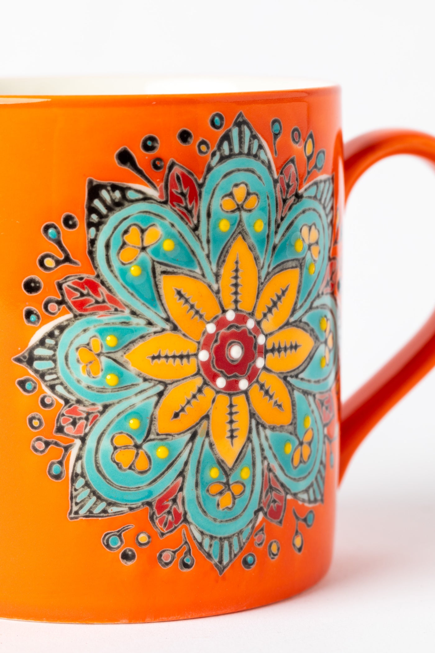 Mandala Mug in orange with embossed floral mandala design.