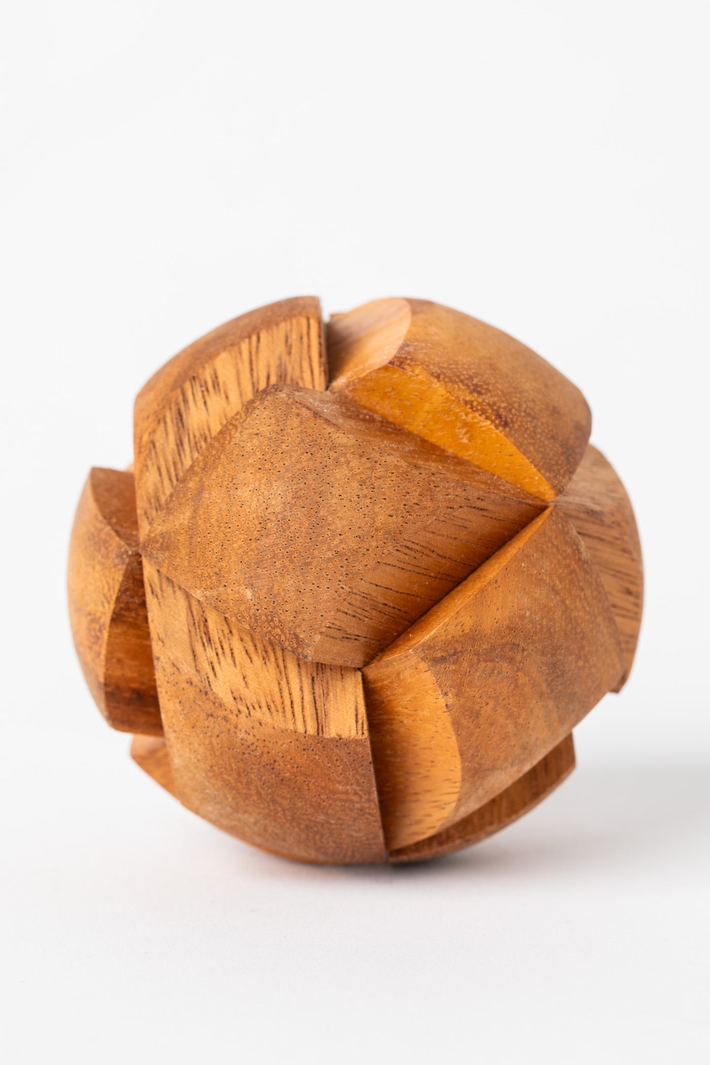 Round wooden sphere puzzle with interlocking pieces handcrafted from natural wood.