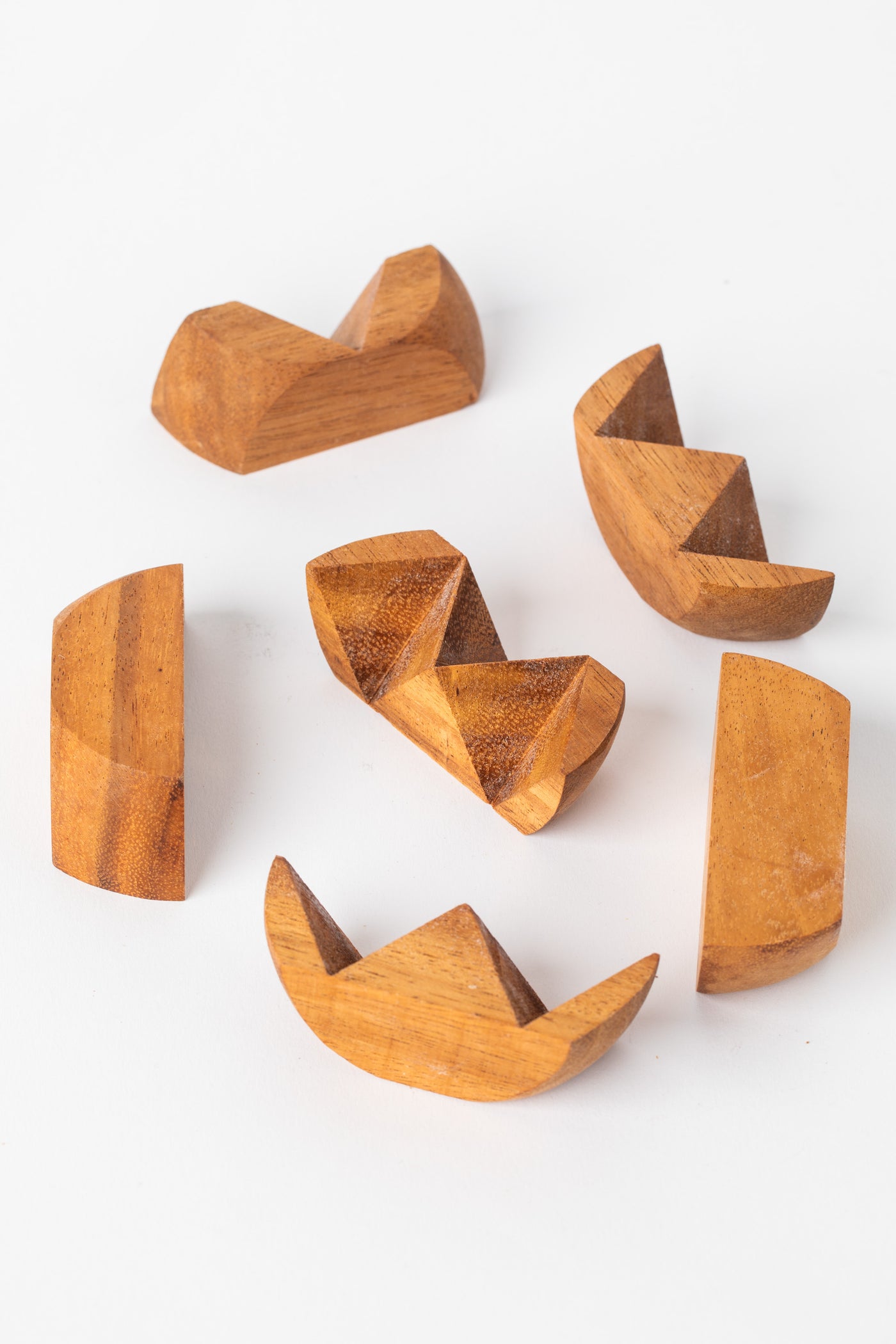 Disassembled wooden ball puzzle showing multiple carved wooden segments.