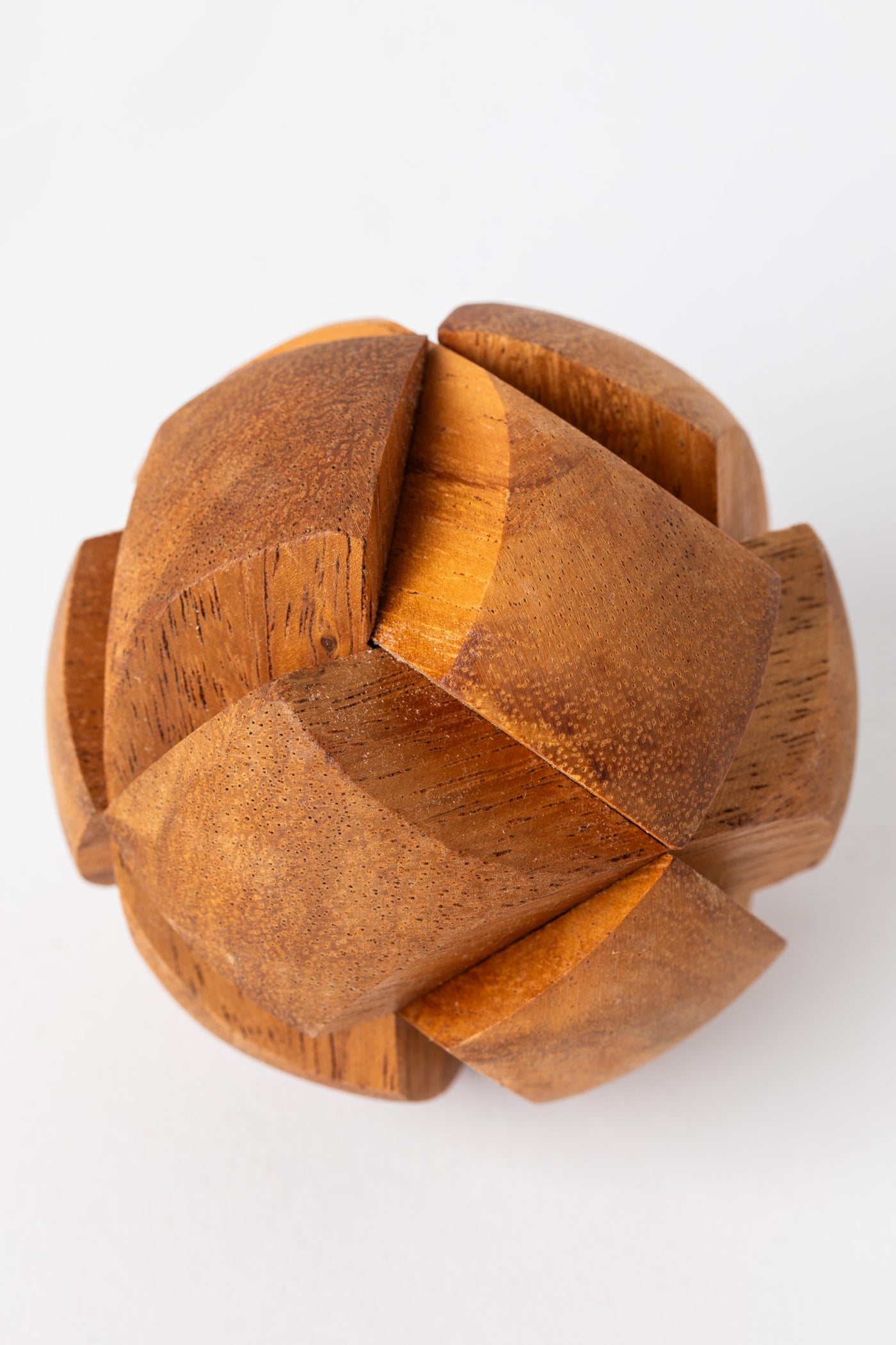 Round wooden sphere puzzle with interlocking pieces handcrafted from natural wood.